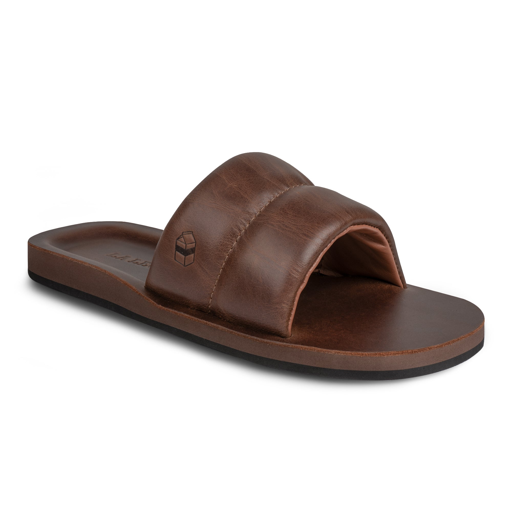 Side angle view of The Bayside Leather Slide by StockyardX, showcasing the plush leather detail and artisan design. This bayside sandal combines style and comfort, made from durable full grain leather. Handmade in La Antigua Guatemala & Oaxaca Mexico, it's a testament to small batch production and skilled craftsmanship.