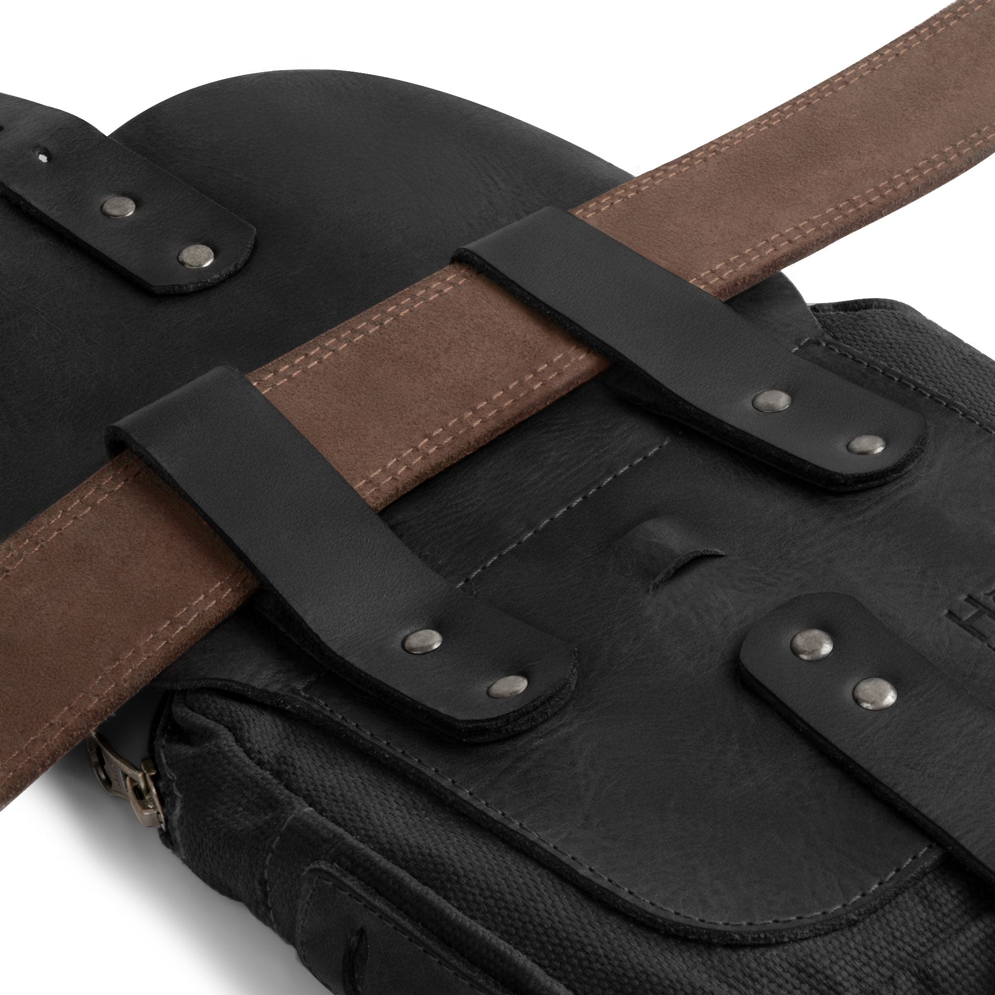 Close-up of the straps on the Survival Camping Pouch by Hide & Drink showing its secure design. Made with Water Resistant Waxed Canvas & Full Grain Leather, this handmade bag is perfect for a survival kit and outdoor tools.