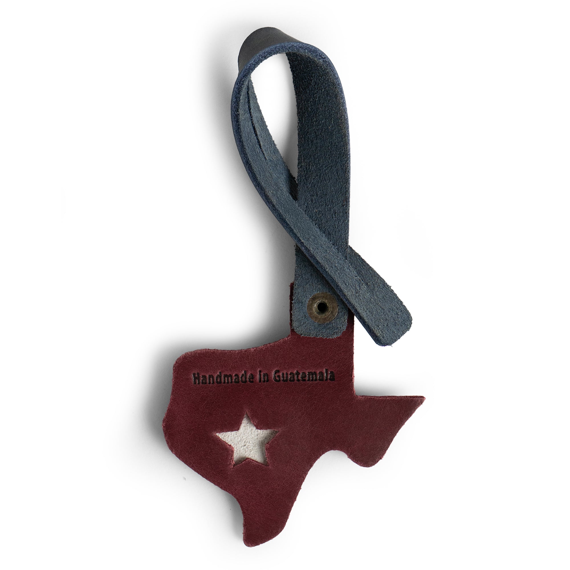 Bag Charms by Austin Genuine includes a Texas charm with a label 'Handmade in Guatemala.' This Austin Genuine Bag Charm showcases 7 unique designs made with full grain leather from StockyardX, crafted through small batch production, hand cut, hand sewn, and fire branded, artisan, handmade in La Antigua Guatemala & Oaxaca Mexico.