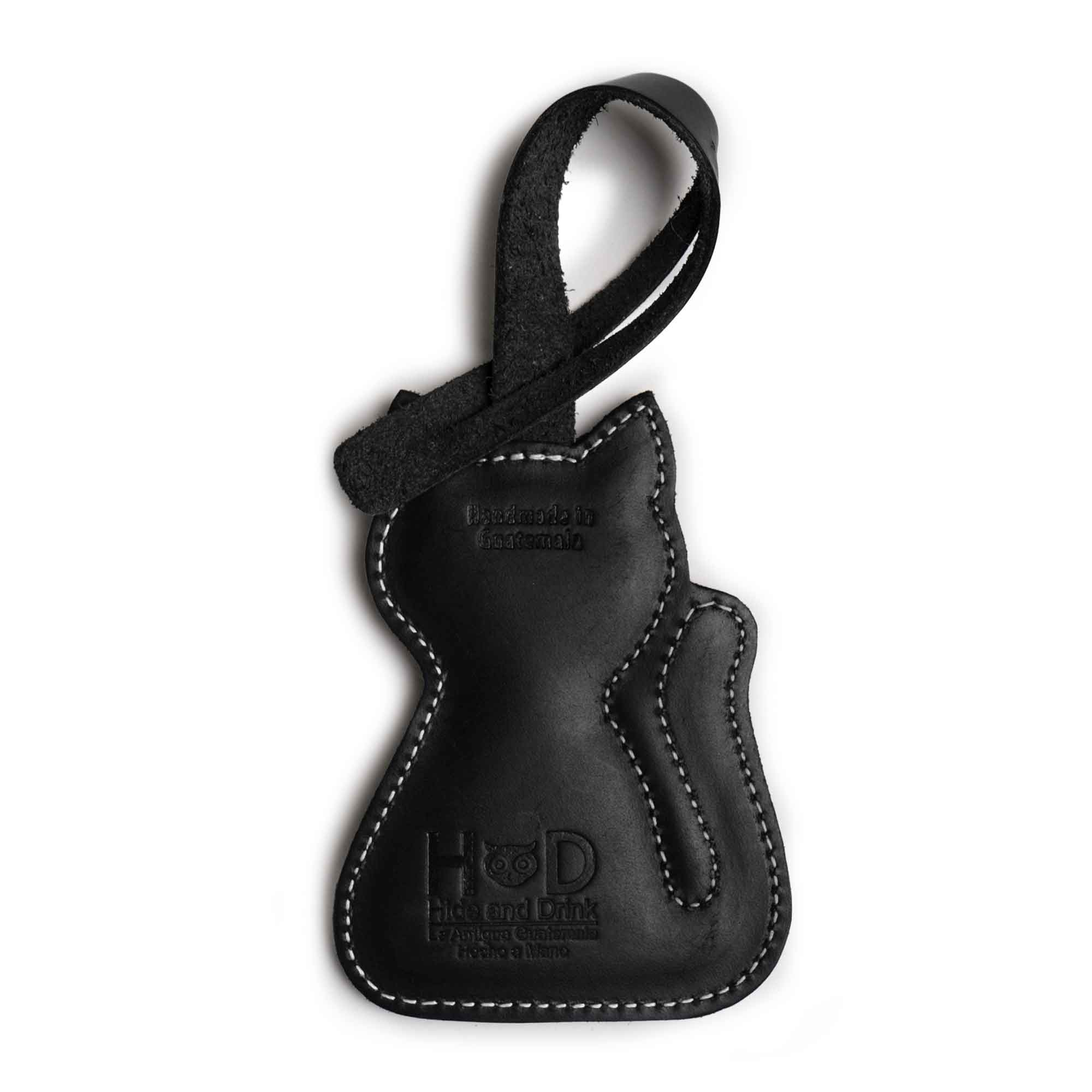 Hide & Drink Bag Charms displaying a unique golden cat design, ideal charm for handbags. This accessory doubles as a purse charm for tote & backpacks crafted from durable full grain leather. Each piece symbolizes StockyardX's small batch production methods, highlighting hand cut, hand sewn craftsmanship and fire branded artistry, handmade in La Antigua Guatemala & Oaxaca Mexico.