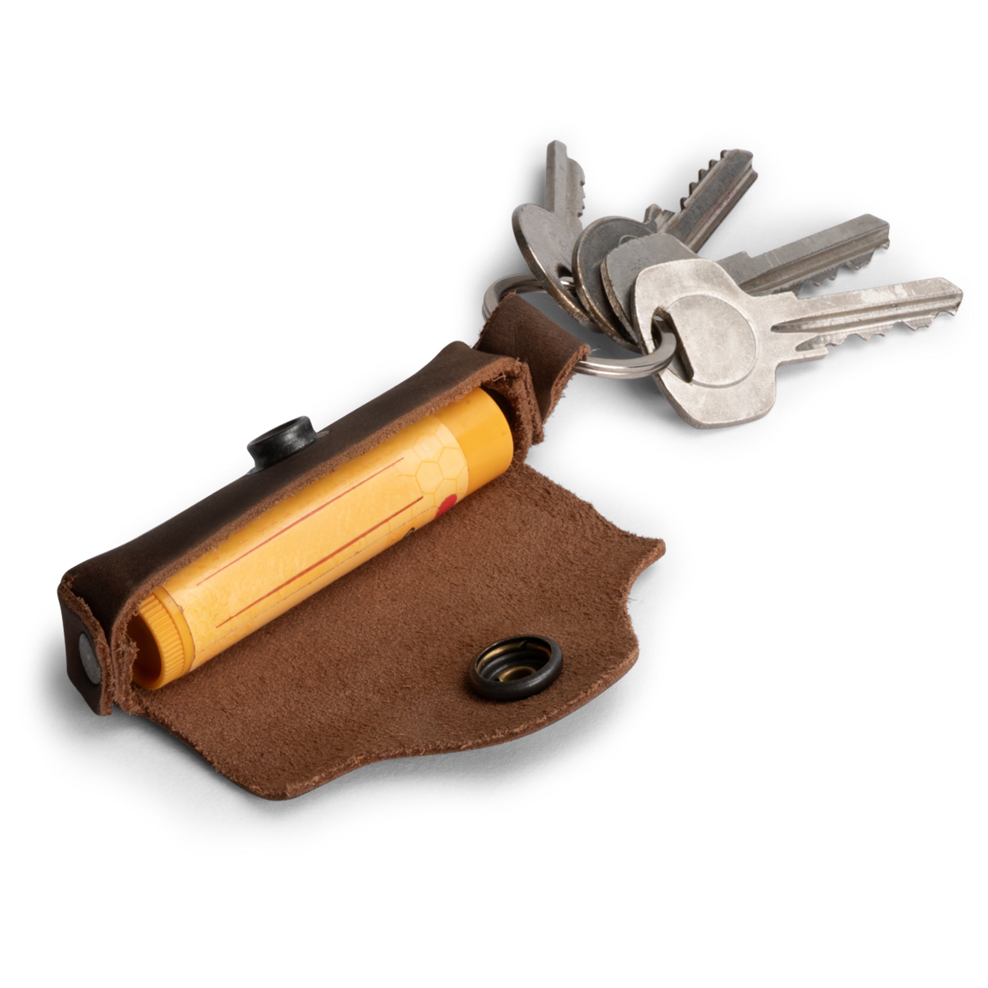 Stylish Lip Balm Key Chain by Hide & Drink showcasing a compact lip balm holder, made from durable full grain leather. Ideal for lip protection with a brass metal clasp. Artisan crafted in La Antigua Guatemala.