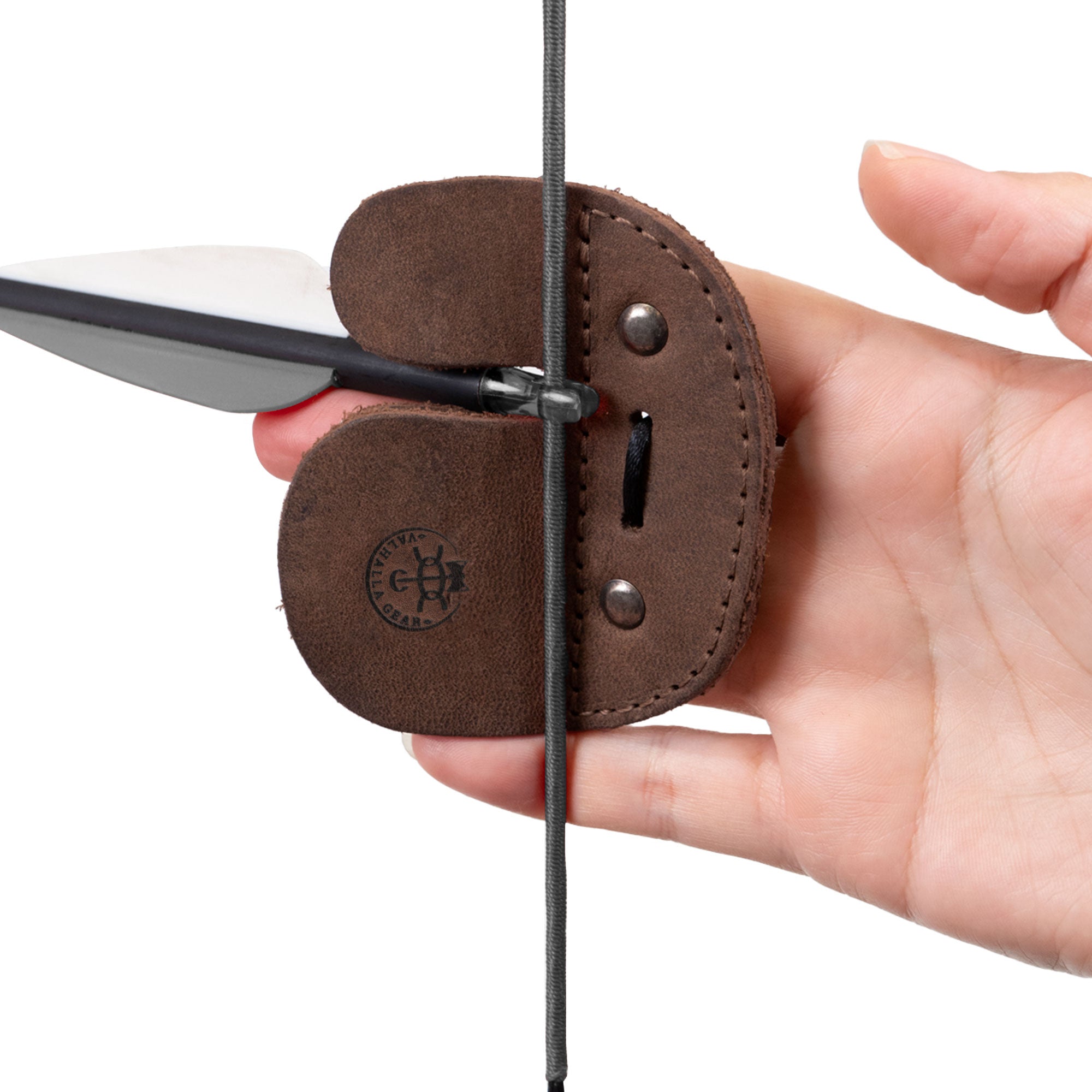 Close-up of the Right Handed Archery Finger Tab from Valhalla Gear being handled to demonstrate its quality and design. This finger protector is essential for shooting practice with recurve bows, made from premium full grain leather. Artisan-crafted in La Antigua Guatemala, this gear combines tradition with functionality for archers.