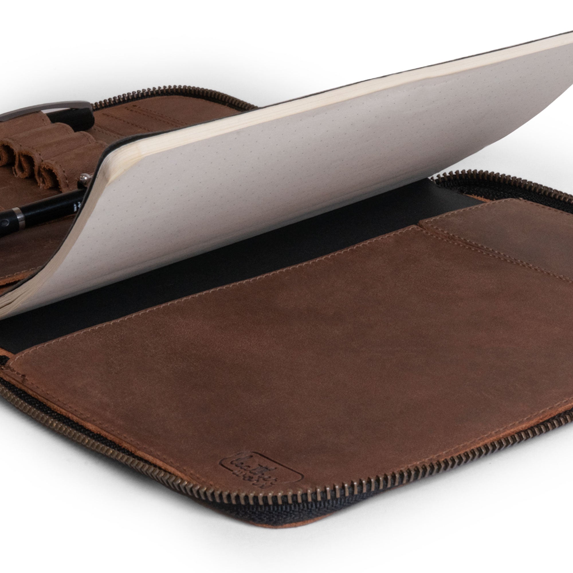 Close-up of the Rustic A5 Notebook (5.75 x 8.25 inch.) Portfolio Binder revealing the interior notebook section, designed by Leather Worx. This is a superb choice as an Executive Padfolio for Office or Personal Planner for Men and Women, crafted from Full Grain Leather, showcasing StockyardX quality, Small Batch Production, Hand Cut, Hand Sewn, Fire Branded, Artisan craftsmanship, Handmade in La Antigua Guatemala & Oaxaca Mexico.