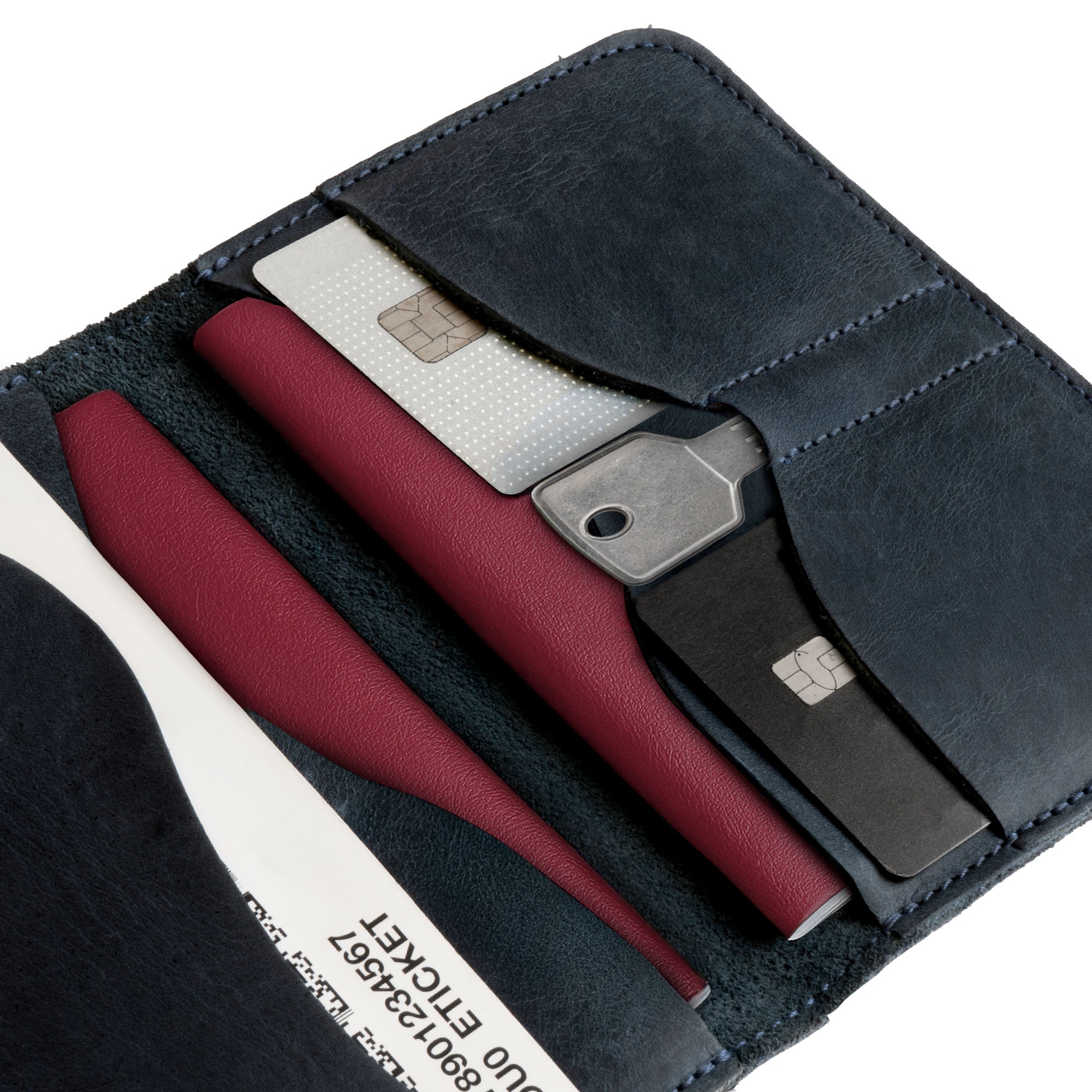 Close-up shot of the navy Hide & Drink Double Passport Wallet W/Key Slot, showcasing the attention to detail in the hand-cut full grain leather and its functionality as a stylish ID organizer.