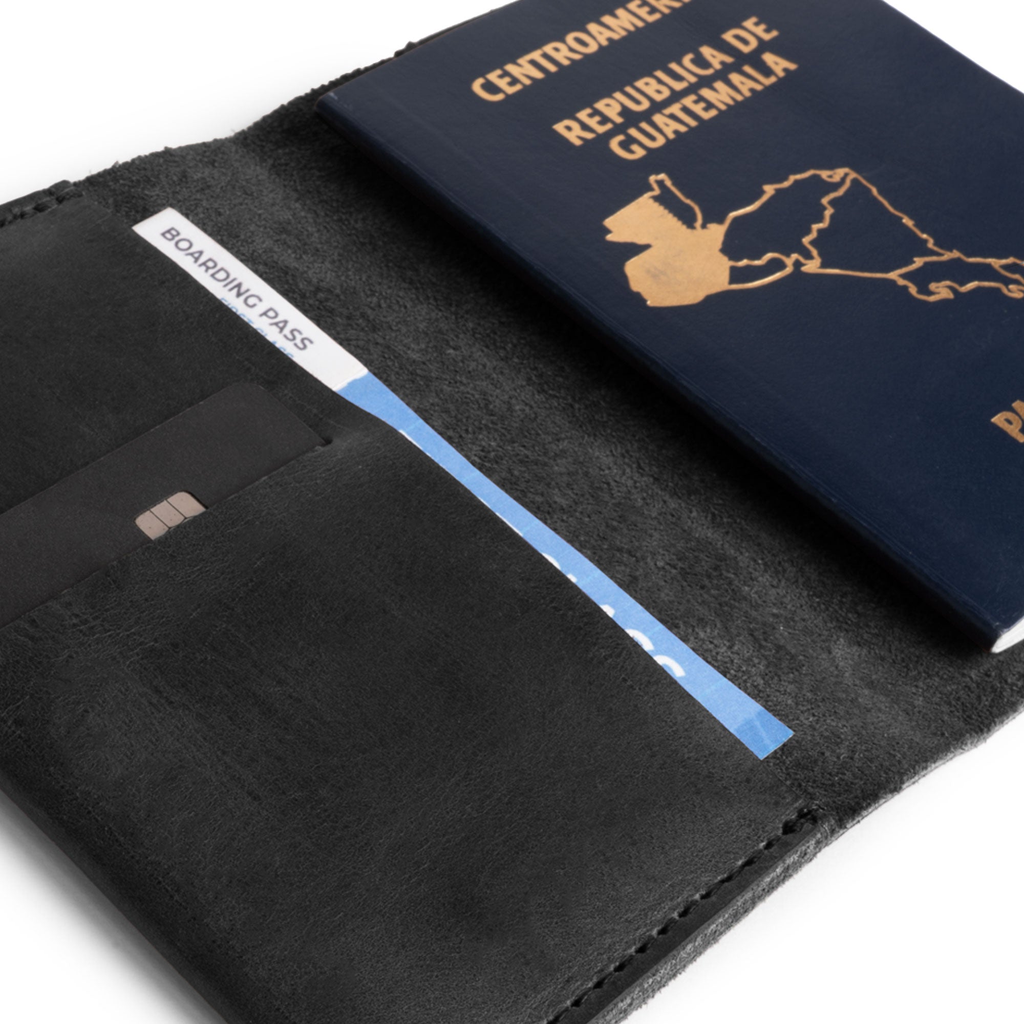 Close view of the Passport Case With Card Holder by Hide & Drink, featuring a sleek black leather exterior with a credit card slot. This essential travel accessory benefits from small batch production and artisan detailing, made from beautiful full grain leather, handcrafted in La Antigua Guatemala & Oaxaca Mexico.