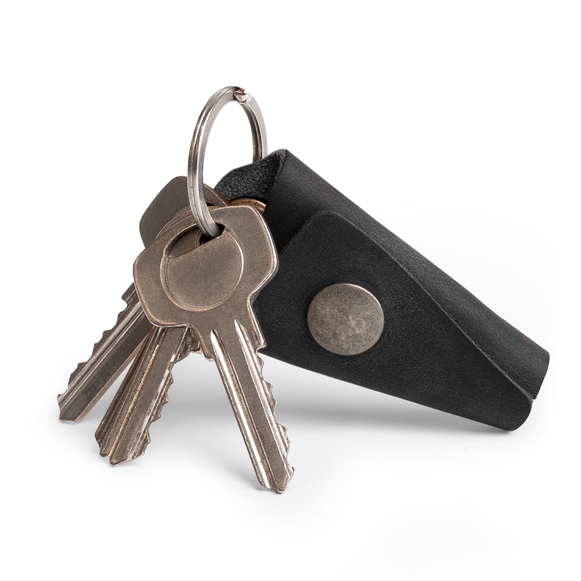 Handcrafted Wrap Keychain by Hide & Drink, designed with an organizer snap closure and made from full grain leather. This key ring cover acts as a silencer sleeve key holder for men, showcasing exceptional artisan craftsmanship. Each piece is handmade in La Antigua Guatemala using small batch production techniques, featuring hand cut and hand sewn details.