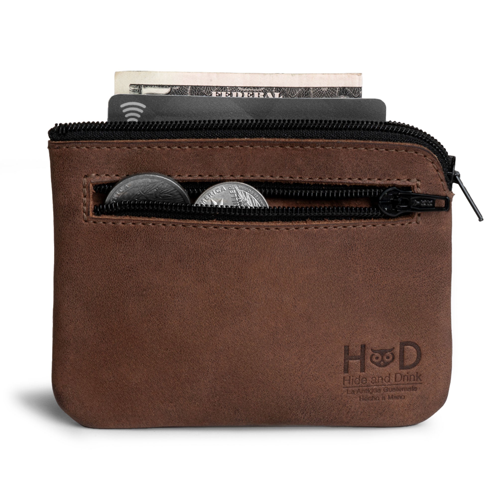 The Double Wallet Coin Pouch from Hide & Drink provides a stylish way to carry coins and cards, made from durable Full Grain Leather. This artisan piece reflects the beauty of small batch production with its hand cut and hand sewn details and a fire branded emblem, handmade in La Antigua Guatemala & Oaxaca Mexico.