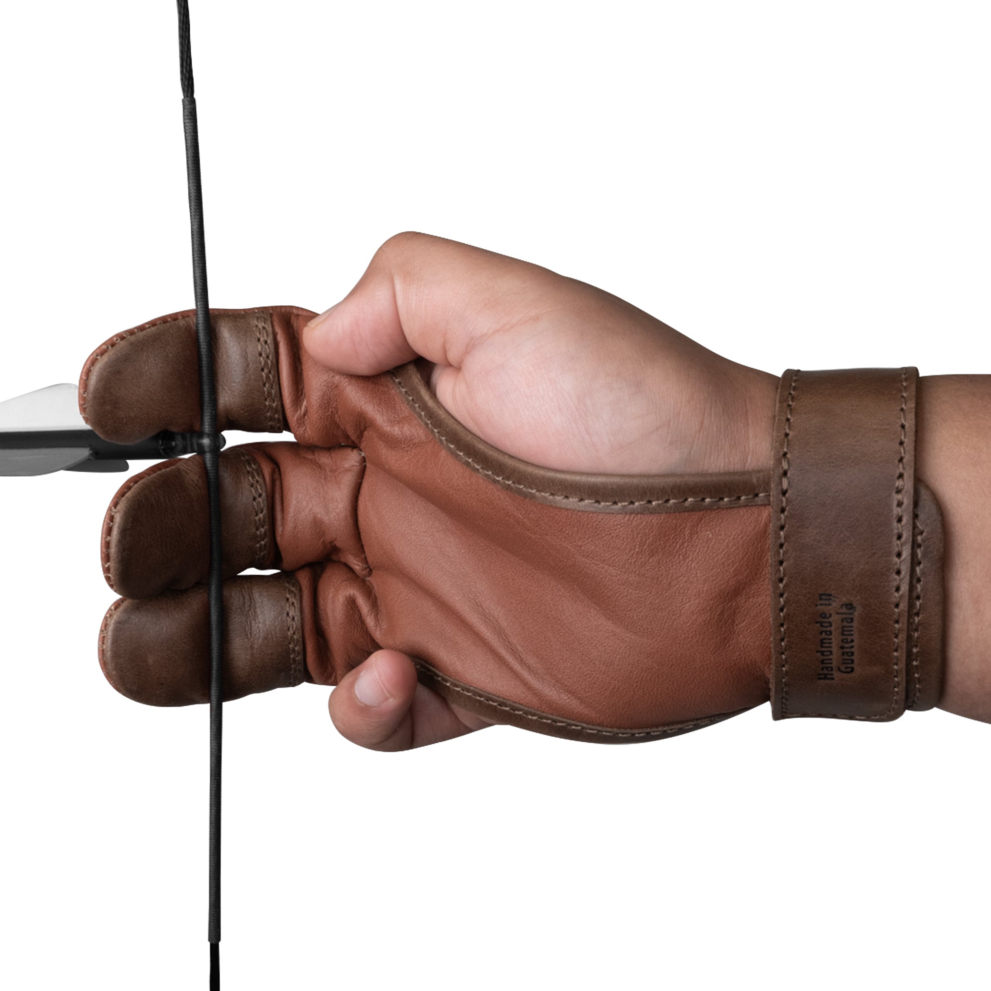 A close-up of a hand gripping an arrow while wearing the Valhalla Gear 3-Finger Archery Glove. The glove's full grain leather offers durability and comfort, making it an essential finger tab for archers. Perfect for outdoor sports, hunting gear for men, women, and youth, this artisan-crafted glove is handmade in La Antigua Guatemala & Oaxaca Mexico.