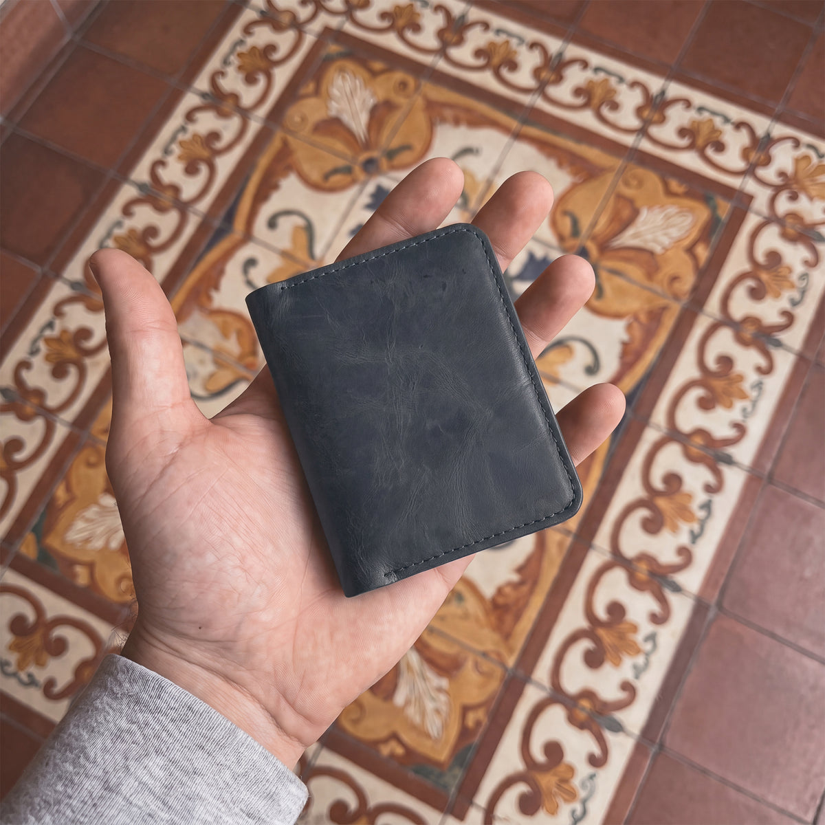 Open view of the Bi-Fold Card Wallet Diagonal by Hide & Drink in brown, illustrating its functionality as a stylish cash and card organizer made from durable leather.
