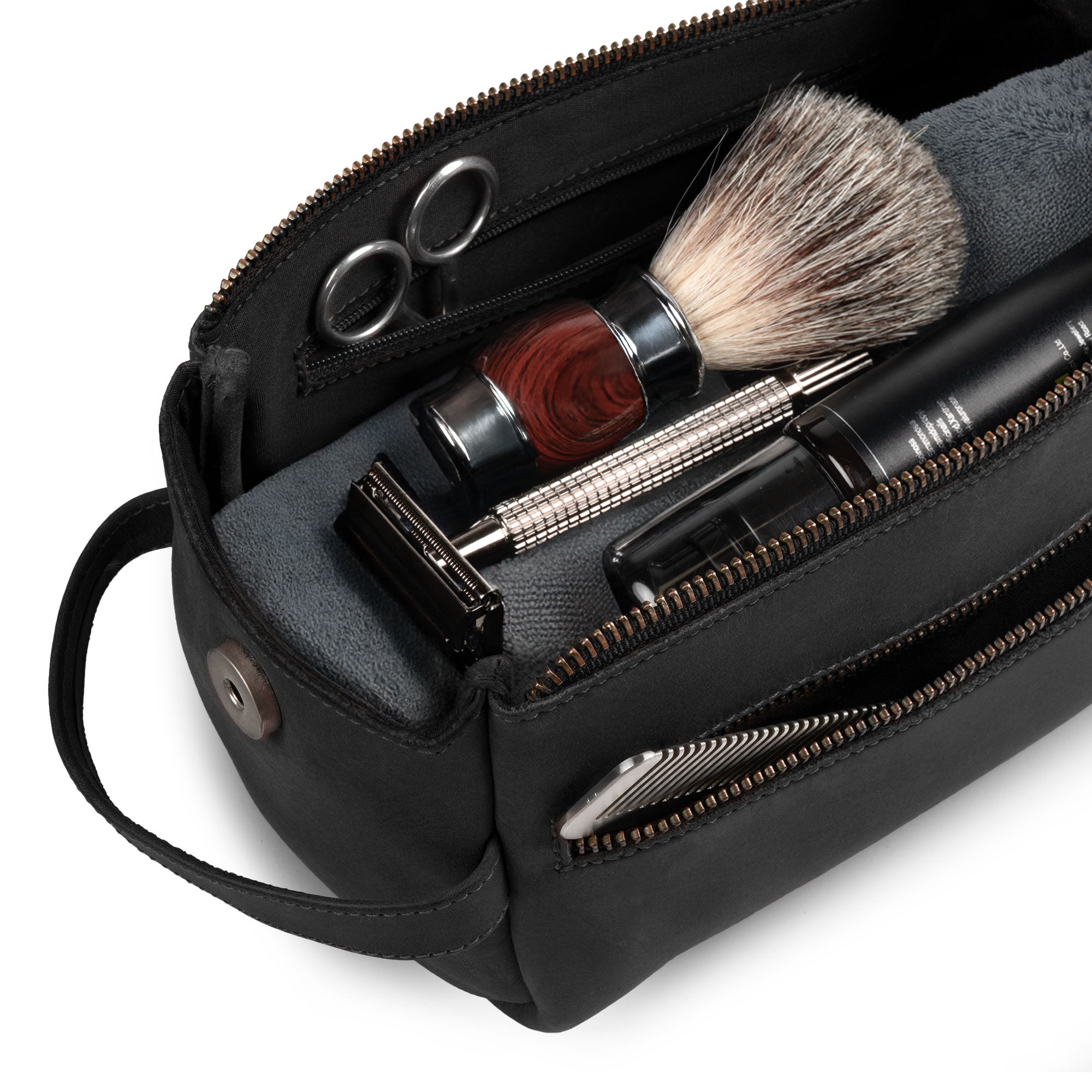 Hide & Drink's Toiletry Bag with grooming essentials shown inside. This Full Grain Leather Toiletry Bag serves as a stylish Hand Bag and Dopp Kit Organizer for daily use. StockyardX, Handmade, S.