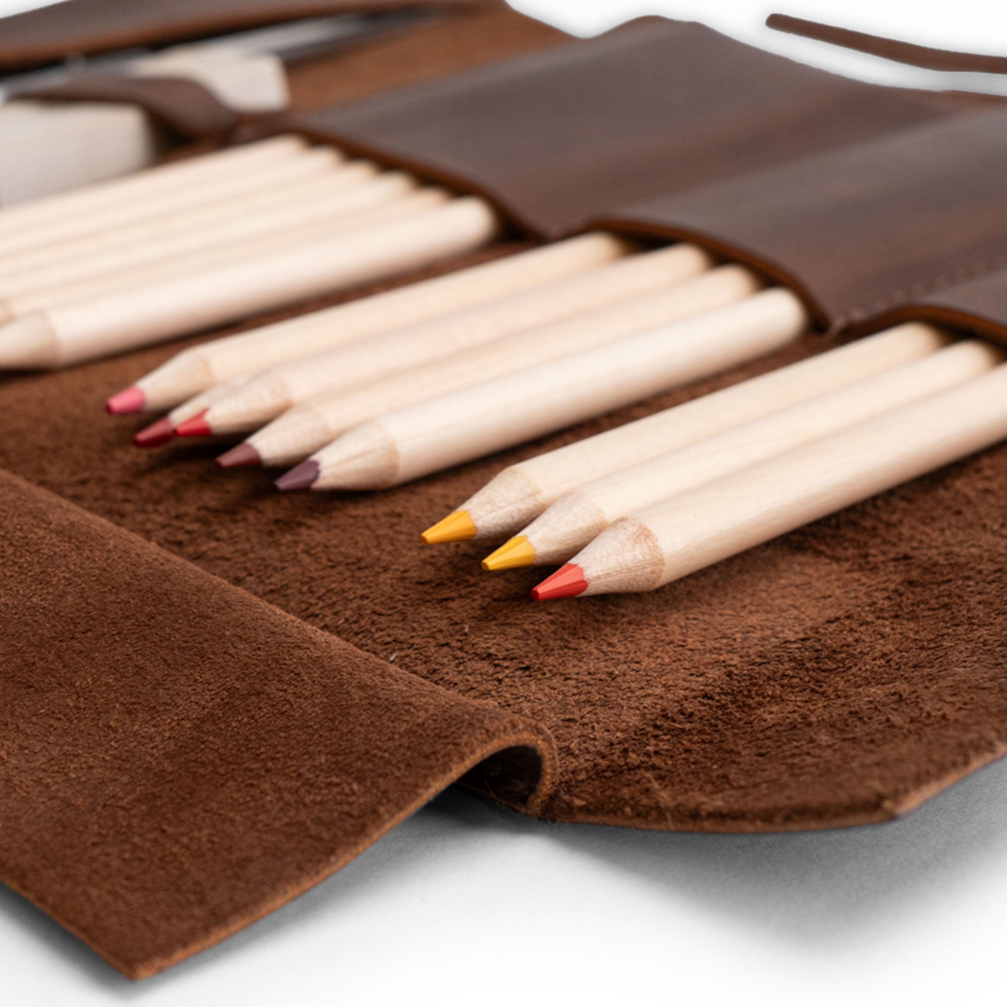 Close-up of the Hide & Drink Multi Purpose Pencil Roll highlighting its beautiful leather texture and colors, designed for versatile storage solutions. This rustic, handmade pencil roll pouch is great for scissors, earphones, and more, featuring artisan craftsmanship from La Antigua Guatemala & Oaxaca Mexico.