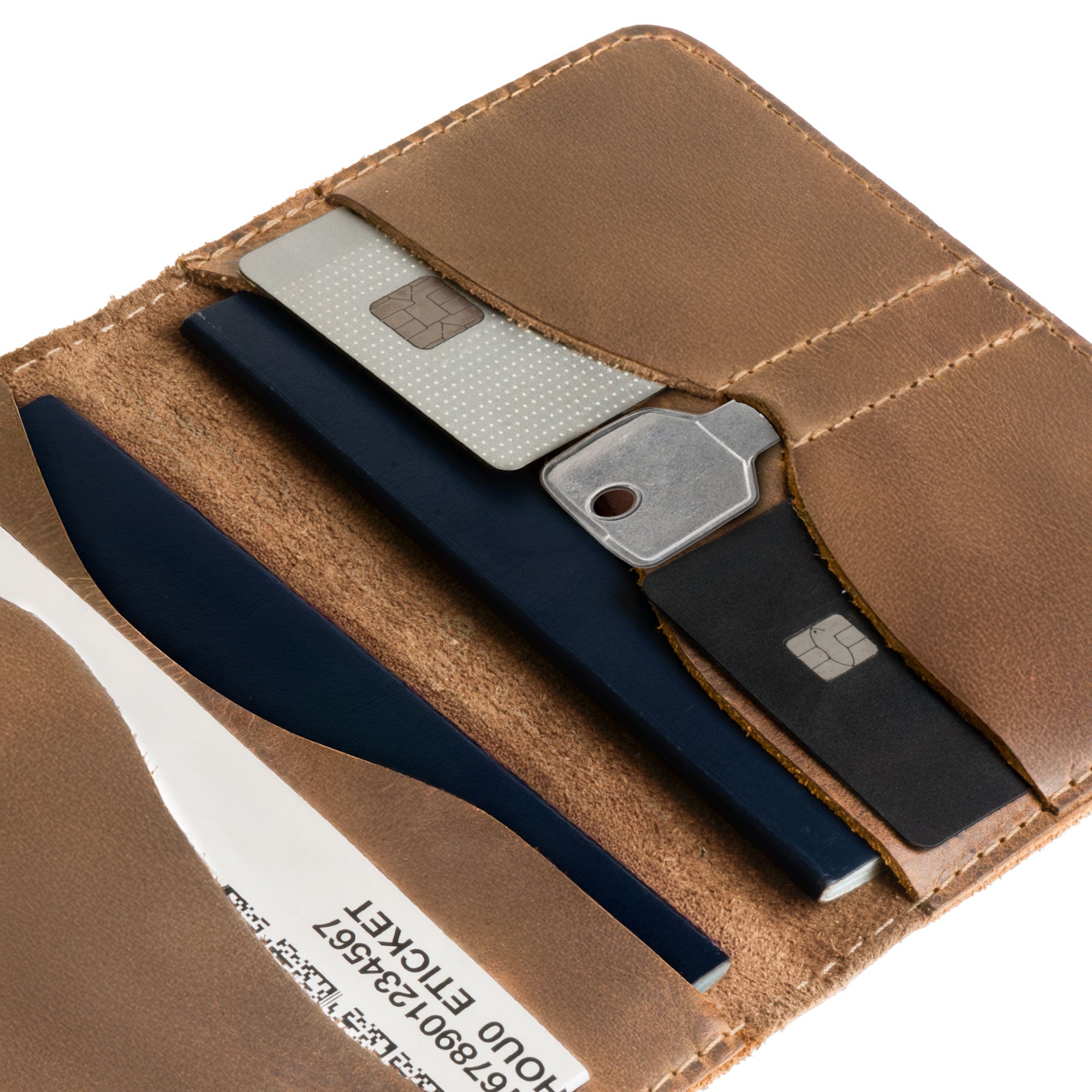 Close-up of the tan Hide & Drink Double Passport Wallet W/Key Slot, emphasizing the fine stitching and craftsmanship, showcasing its functionality as a rustic case for bills and keys.