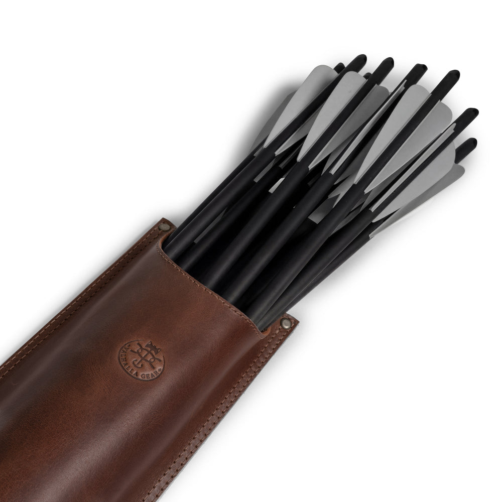 A close-up of Valhalla Gear's The Fletcher, Hip Bolt Quiver featuring a collection of arrows within its full grain leather structure. This product serves as an excellent archery and hunting storage accessory, essential for organizing and holding bolts securely. Hand cut, hand sewn, and fire branded, this artisan quiver adds style and functionality to any archer’s gear, proudly crafted in La Antigua Guatemala.