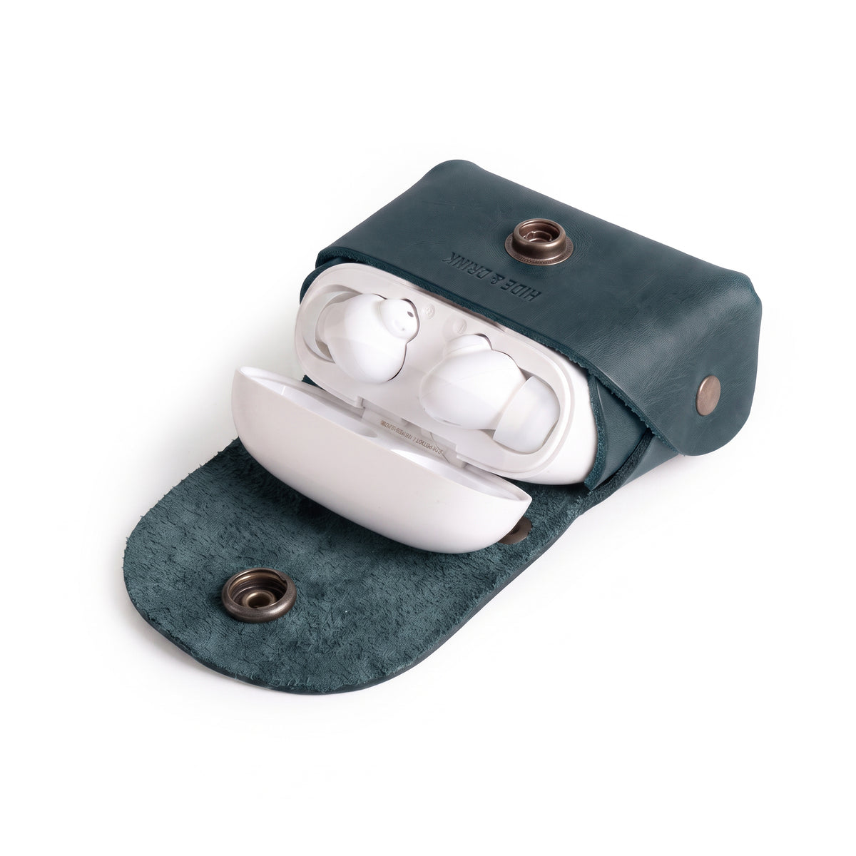 Inside view of the Tiny Handbag Keychain by Hide & Drink, filled with coins to illustrate its usability. This keychain, made from Full Grain Leather, is a great example of handmade craftsmanship from StockyardX, highlighting the artisan skills from Oaxaca Mexico.