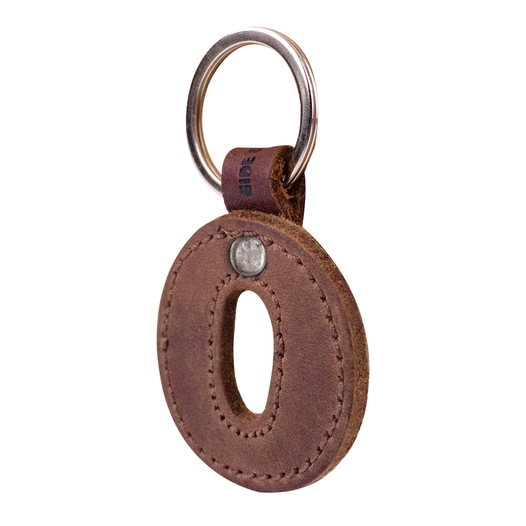 Side view of the letter O in a leather keychain. This handcrafted Alphabet Letter Keychain from Hide & Drink features thick Full Grain Leather, reflecting the artisan's dedication to small batch production in La Antigua Guatemala.