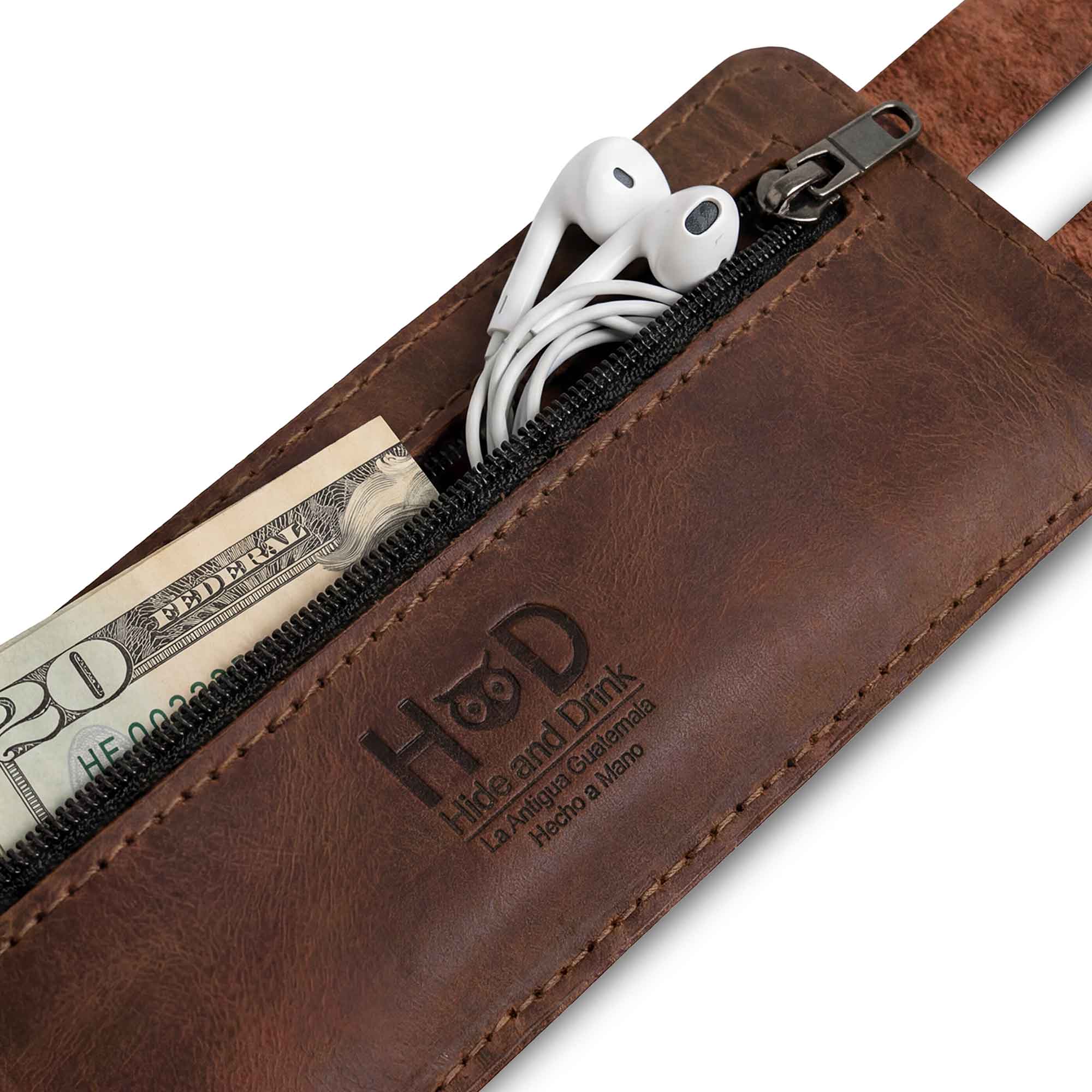 Hide & Drink's Wrist-Wallet-Cuff showcases a hidden pouch for bills, elegantly crafted from Full Grain Leather. This rustic leather bracelet design features an inner zippered pouch for easy organization. Each piece is uniquely handmade in La Antigua Guatemala & Oaxaca Mexico, highlighting skilled artisanal craftsmanship and fire-branded details.
