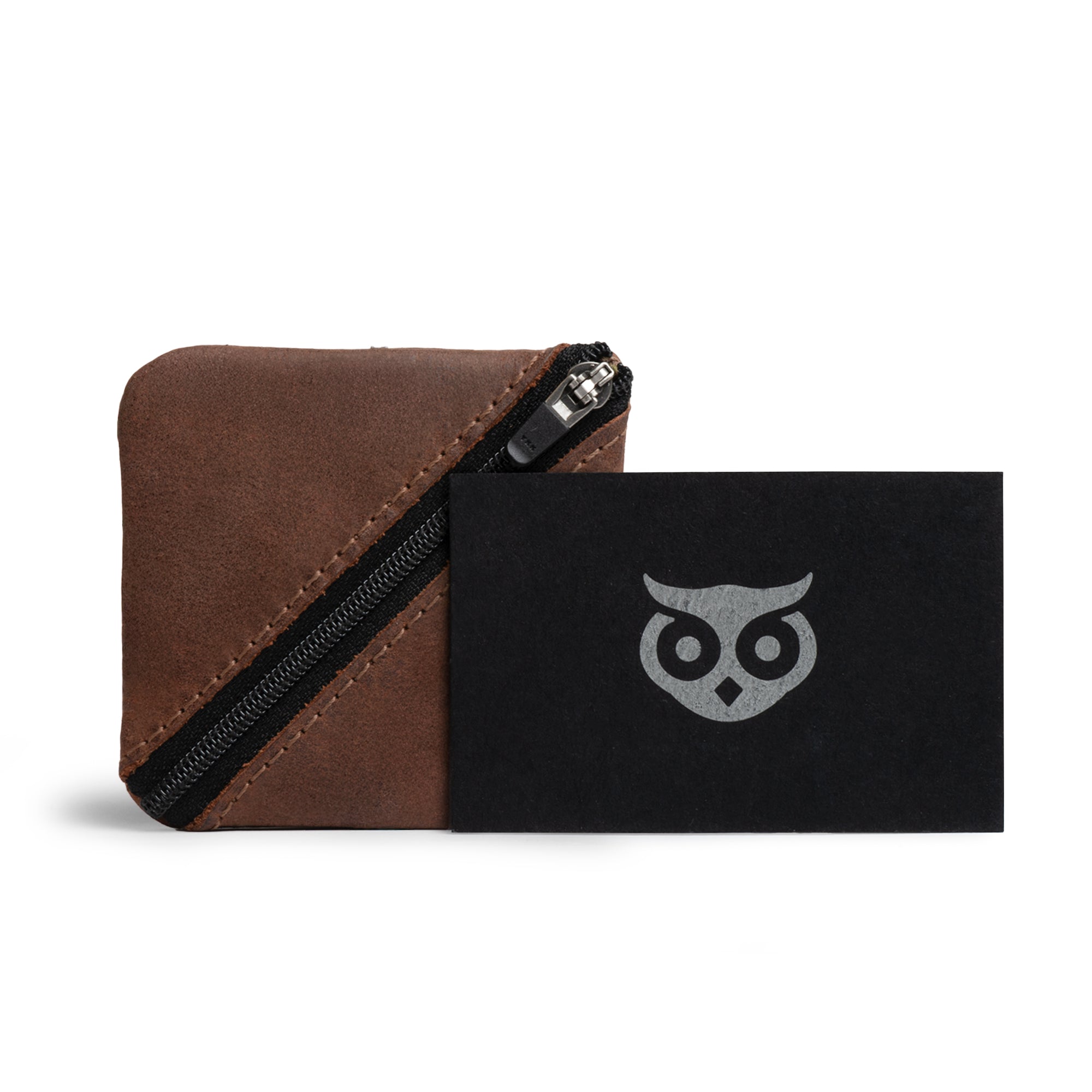 The complete packaging of the Slash Zippered Pouch by Hide & Drink, showcasing artisan quality along with a story of small batch production. This full grain leather pouch is perfect as a change holder, ensuring better organization in your pocket or purse, handmade in La Antigua Guatemala & Oaxaca Mexico.