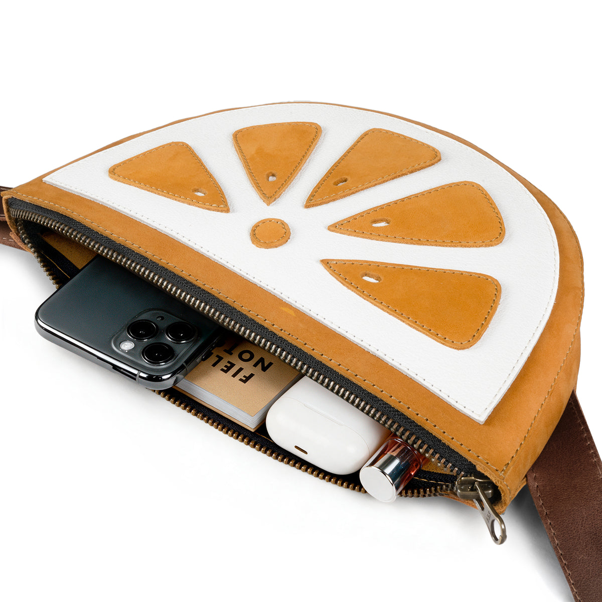 Open Tudi Frudi Lemon Crossbody showing space for a phone, earbuds, and essentials, designed as a Lemon Crossbody Bag and Shoulder Bag from Full Grain Leather for StockyardX with Small Batch Production, Hand Cut, Hand Sewn, Fire Branded, Artisan craftsmanship, Handmade in La Antigua Guatemala & Oaxaca Mexico.