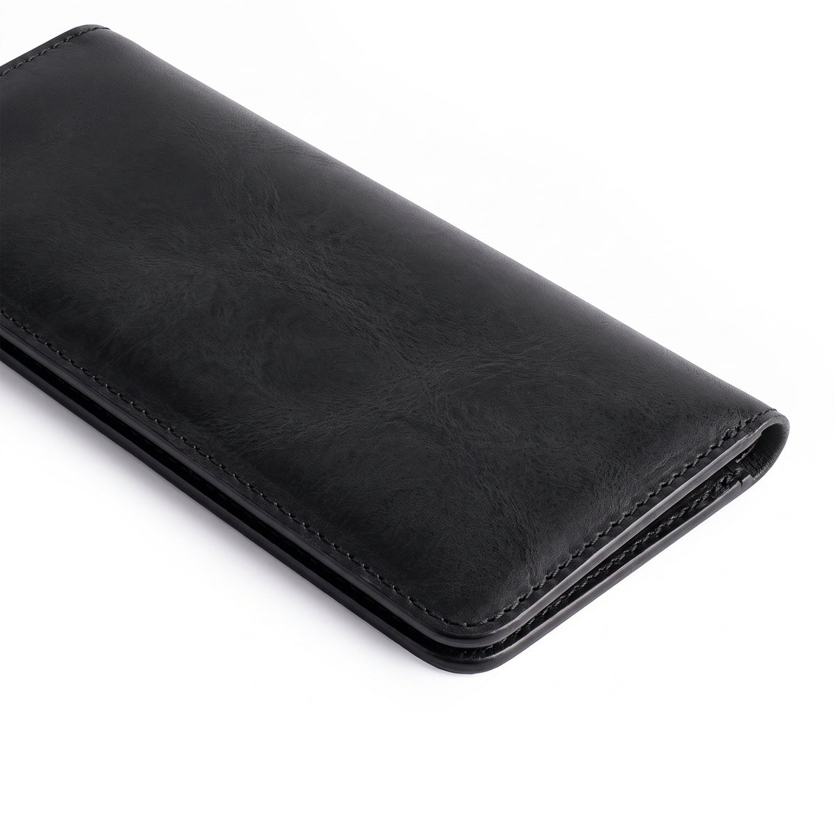 Sleek black bifold wallet for cellphone by Hide & Drink, showcasing its minimalist design. This modern Bifold Wallet for Cellphone is constructed from high-quality Full Grain Leather for long-lasting use. Appreciate the artisan craftsmanship through small batch production in La Antigua Guatemala & Oaxaca Mexico.