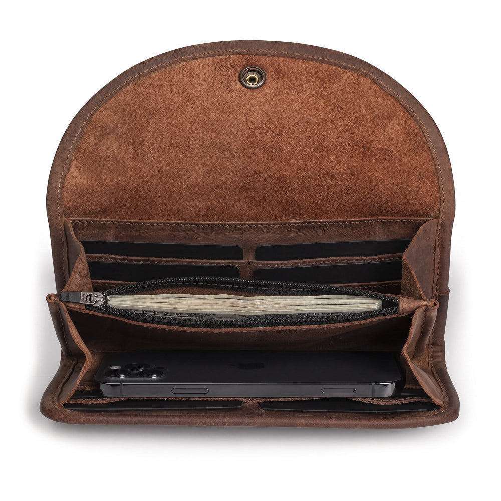 Inside view of the Single Snap Zippered Wallet by Hide & Drink, showcasing compartments for cards and a zippered pouch. This Snap Clutch Wallet for Women is a durable money holder and card organizer made from full grain leather, featuring small batch production, hand cut, and hand sewn details. Artisan crafted in La Antigua Guatemala.