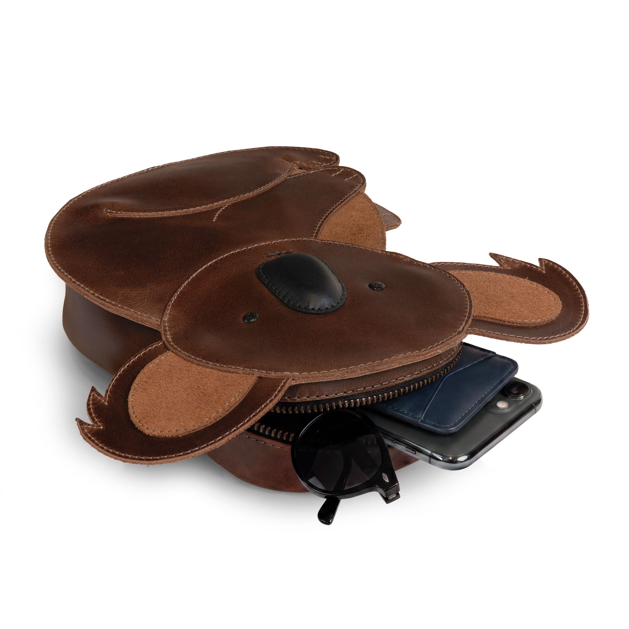Open view of the Tudi Frudi Leather Koala Crossbody Bag displaying its zippered compartment, perfect for storing essentials. Ideal as a messenger bag or travel backpack, this artisan-made bag highlights the unique craftsmanship of full grain leather, handmade in La Antigua Guatemala and Oaxaca Mexico.