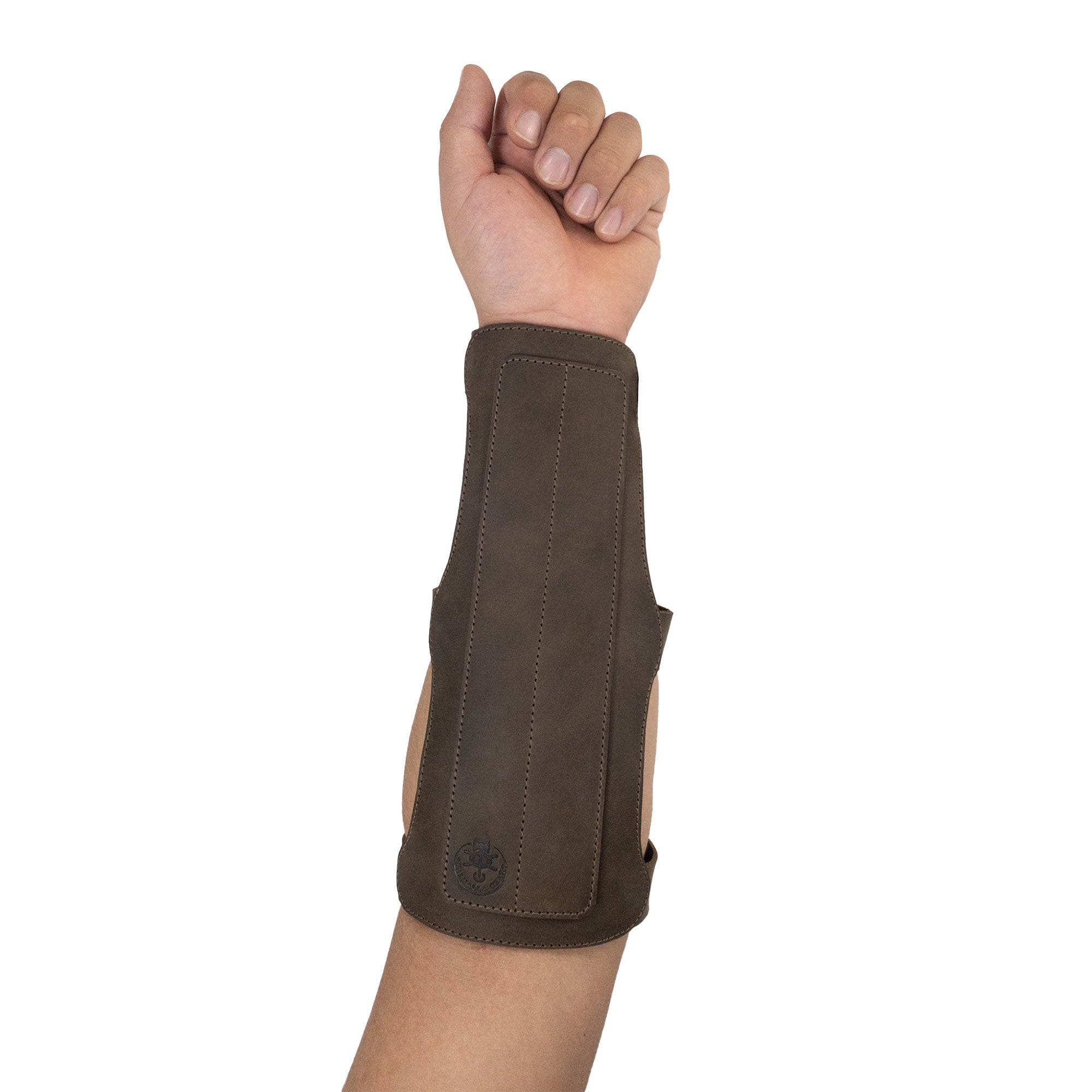 A hand wearing the 3-Buckle Archery Bracer from Valhalla Gear. This forearm protector for bow shooting practice is made of full grain leather and features adjustable buckle straps. Artisan handmade in La Antigua Guatemala, this 3-Buckle Archery Bracer offers durability and style for archery enthusiasts.