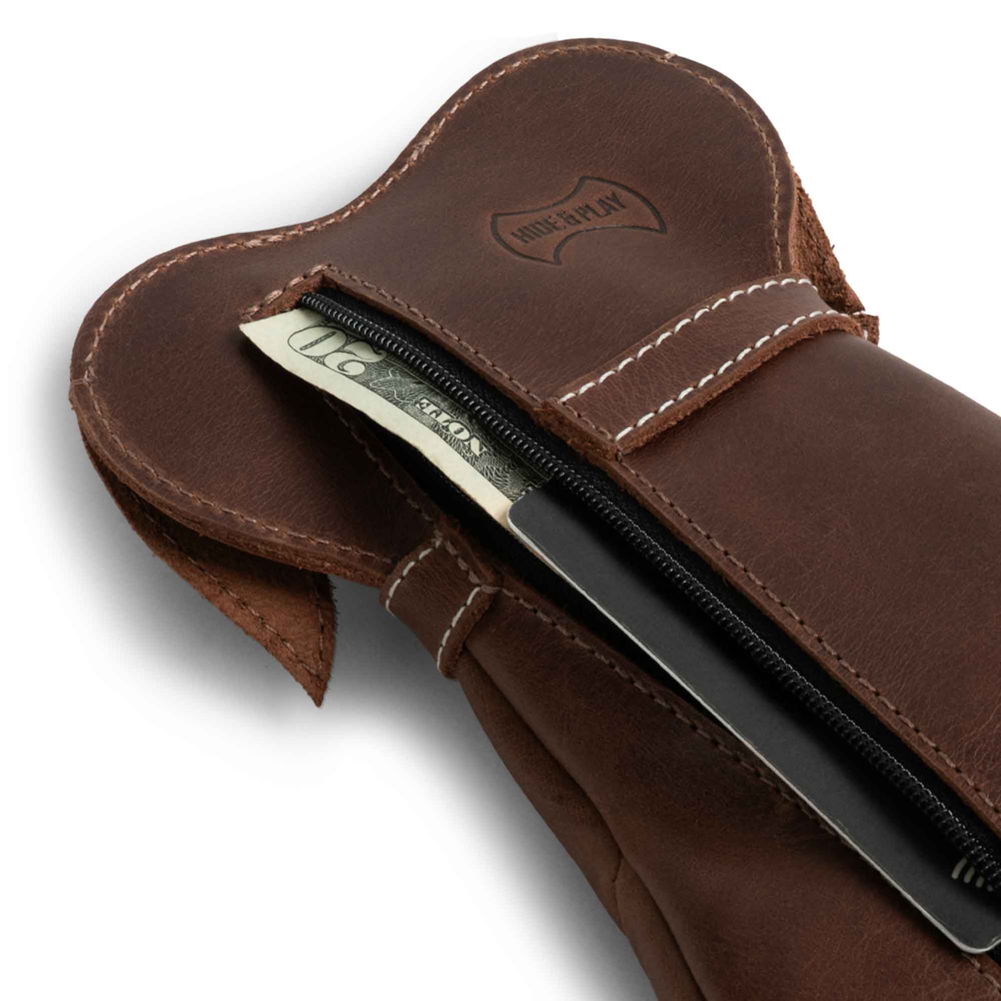 Close-up of the Leather Doggy Pouch by Hide & Play, displaying coins and a bill inside the zipper. This Leather Doggy-Shaped Coin Pouch Piggy Bank is an excellent Cash Holder Organizer, functioning as a Coin Purse for Men & Women and a unique Money Saving Box. Ideal as a Small Mens Wallet for Coins, this pouch features artisan craftsmanship from La Antigua Guatemala and Oaxaca Mexico.