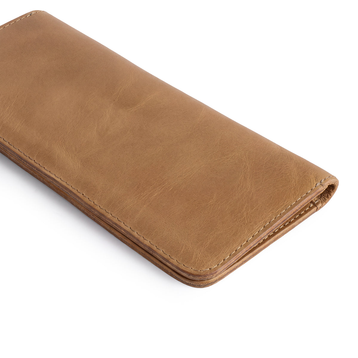 Closed view of the rustic bifold wallet for cellphone by Hide & Drink, focusing on its durable leather. This Bifold Wallet for Cellphone is a stylish accessory made from Full Grain Leather, perfect for daily essentials. Enjoy the artisan craftsmanship in this piece, made through small batch production in La Antigua Guatemala & Oaxaca Mexico.
