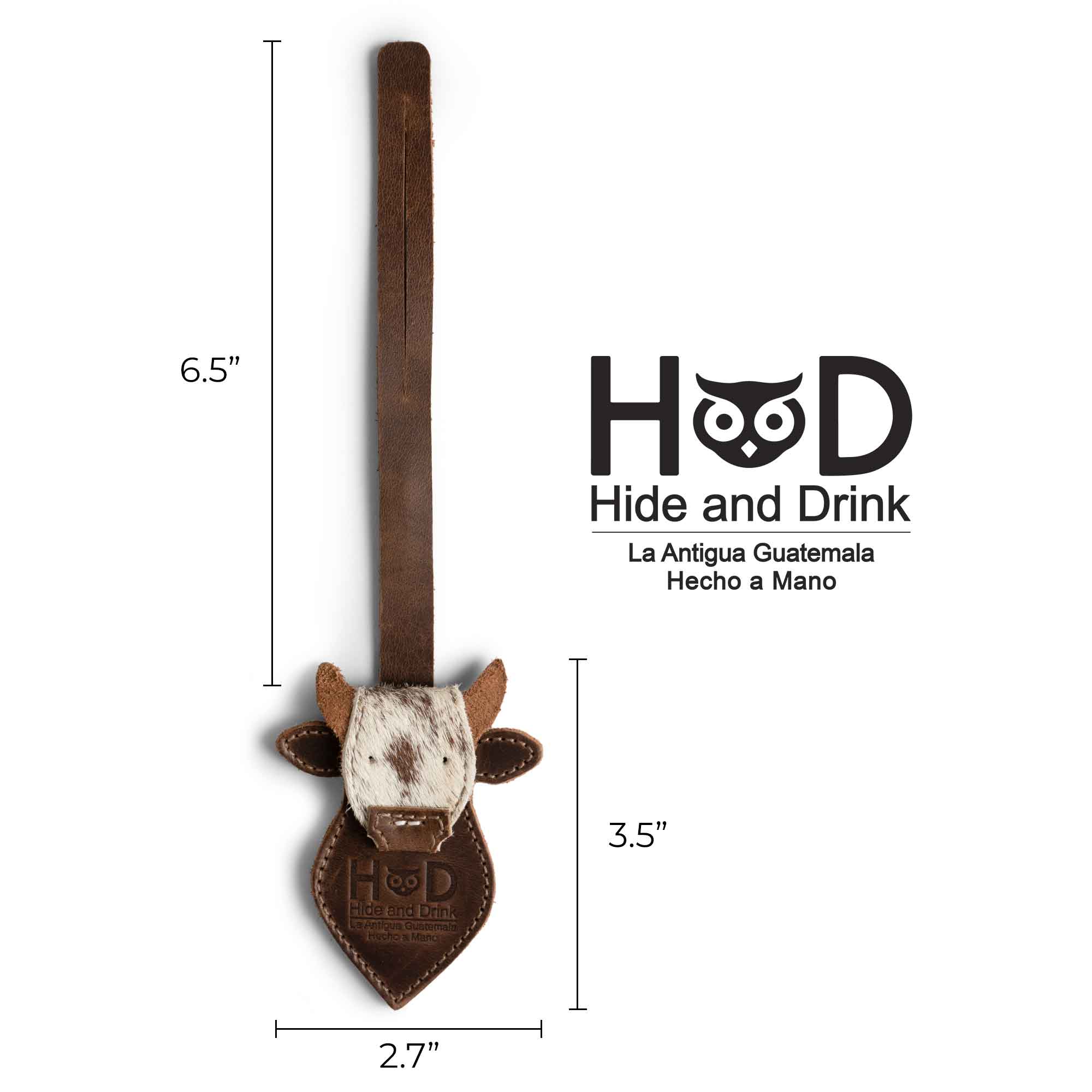 Hide & Drink Bag Charms showing dimensions for a cow head design. This charm for handbags serves as a purse charm for tote & backpacks, made from durable full grain leather. Signifying StockyardX's dedication to small batch production, each piece highlights hand cut, hand sewn artistry combined with fire branding, handmade in La Antigua Guatemala & Oaxaca Mexico.