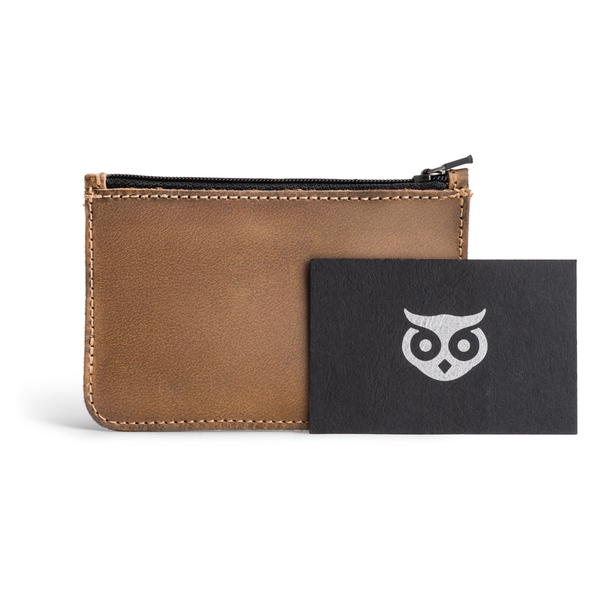 Hide & Drink Zippered Wallet displayed with a business card, showcasing its elegant design and functionality as a folded bills storage and card case. This wallet represents artisan craftsmanship and small batch production using quality full grain leather.