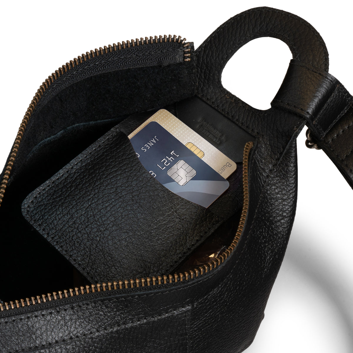 Austin Genuine The Mueller Hobo Shoulder Bag opened to show space for a phone, passport, and daily essentials, made with durable Full Grain Leather and StockyardX Artisan craftsmanship through Small Batch Production, Hand Cut, Hand Sewn, Fire Branded, Handmade in La Antigua Guatemala & Oaxaca Mexico.