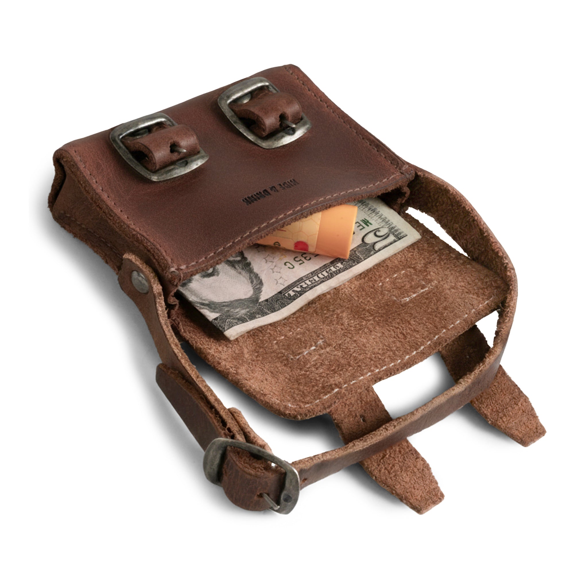 Inside view of the Tiny Messenger Bag by Hide & Drink, showcasing this Mini Messenger Bag Charm's unique design with cash and coins. Crafted from durable Full Grain Leather, this keychain is an artisan piece made in La Antigua Guatemala, reflecting small batch production and careful hand craftsmanship.