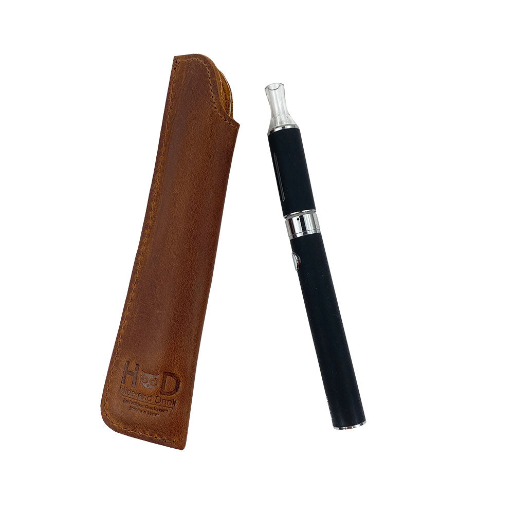 The Hide & Drink Vape Pen Sleeve next to a vape pen, made of quality Full Grain Leather. This handmade artisan piece is fire branded and perfect for storing vape pens. Crafted through small batch production and handmade in La Antigua Guatemala & Oaxaca Mexico. Pen Case.