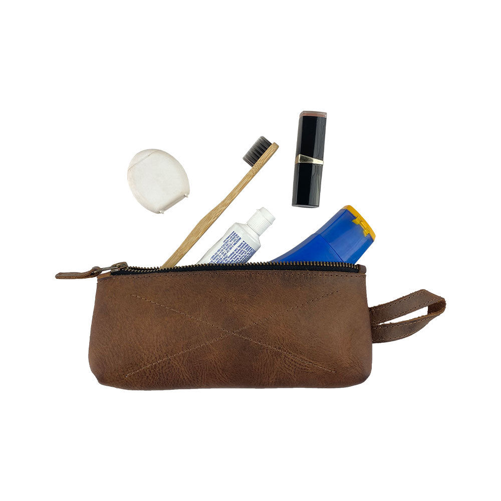 Hide & Drink's X Stitched Case, an artisan-made pen and pencil case crafted from durable full grain leather. This travel essential combines style and function, perfect for organizing utensils and small items, handmade in La Antigua Guatemala and Oaxaca, Mexico.