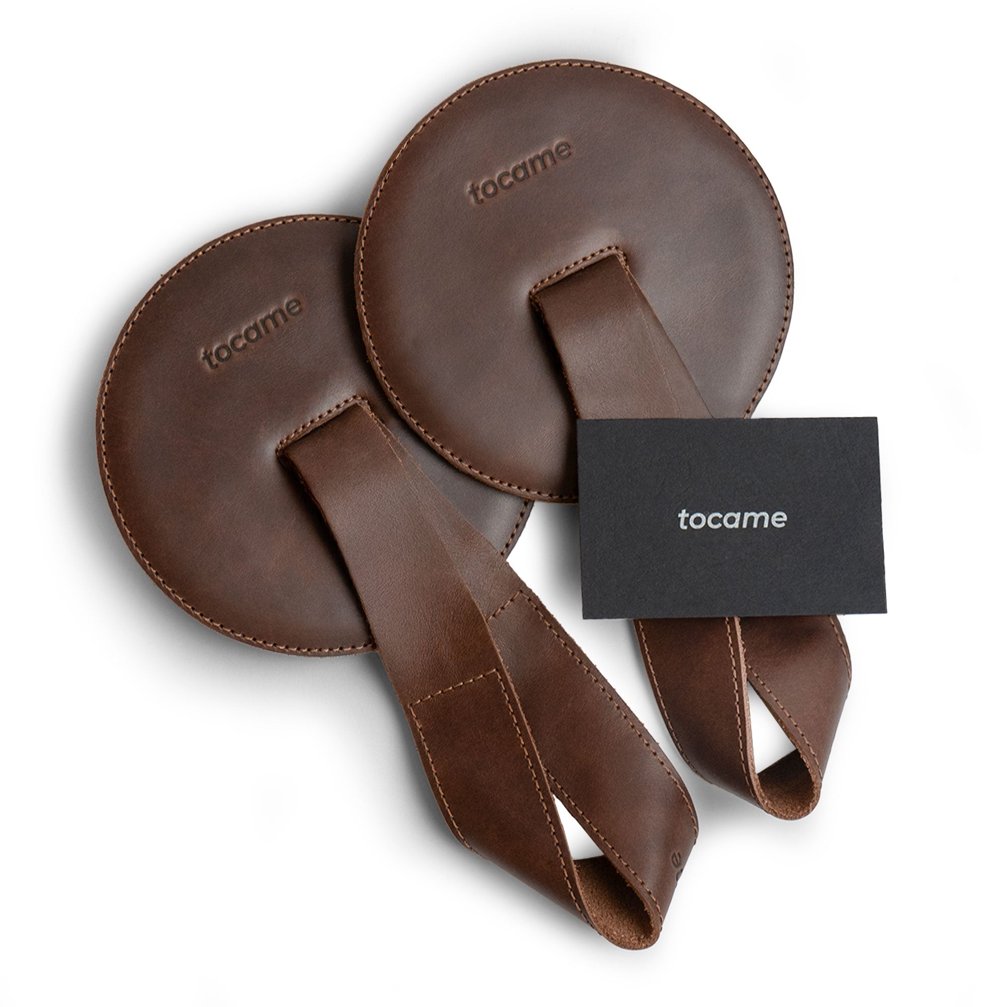 Tocame's Set of 2 Cymbal Pads, highlighting the beautiful craftsmanship with a leather strap and branding. These circular cushions are made for percussionists, combining comfort with style. Handmade in La Antigua, Guatemala, using full grain leather for durability.