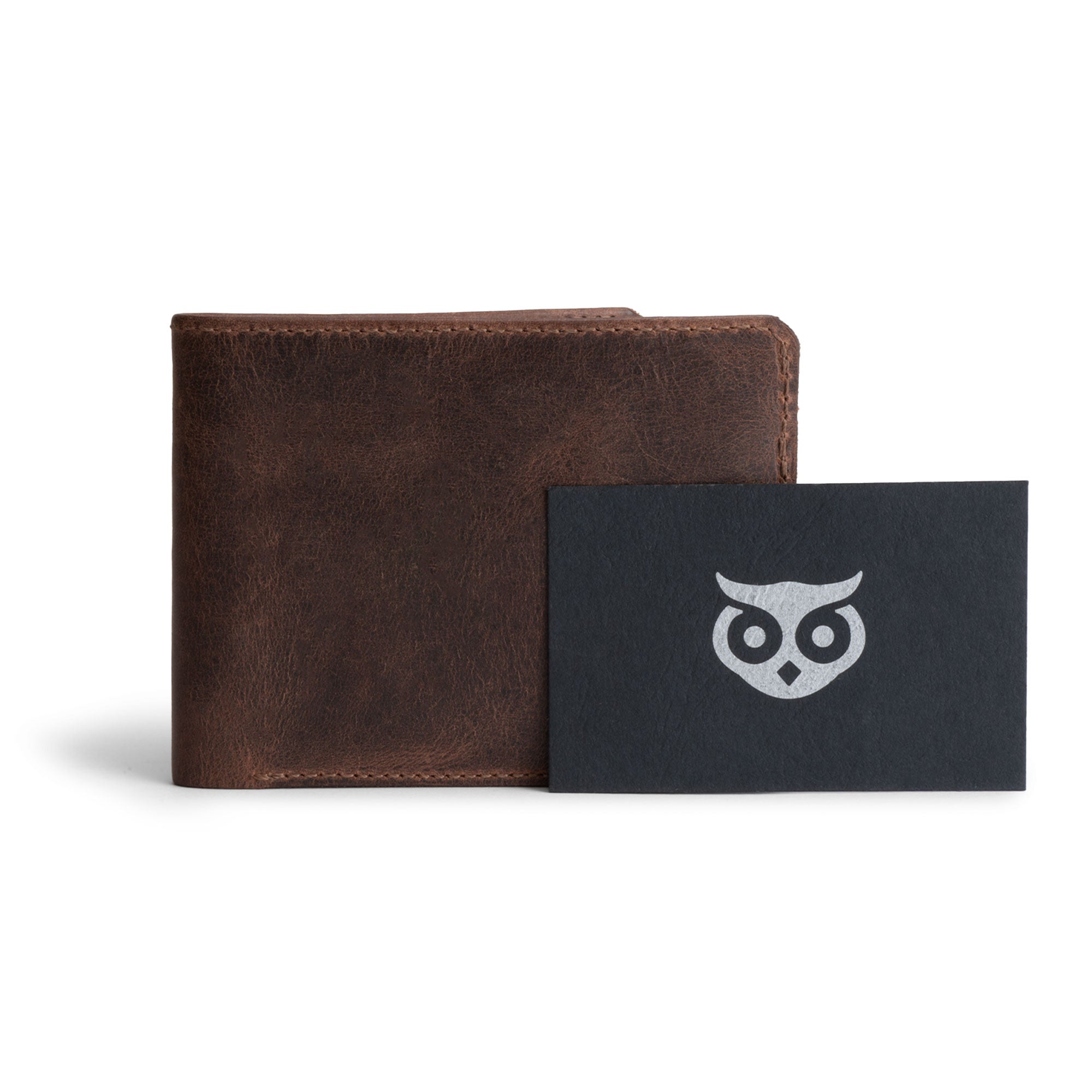 Hide & Drink‚Äôs Bifold Wallet alongside the Stockyard Exchange card, highlighting the artisan craftsmanship. This Slim Bifold Wallet serves as a classic billfold for your pocket or bag, adept at storing cash and cards, making it a wonderful travel accessory, handcrafted from full grain leather in La Antigua Guatemala & Oaxaca Mexico.