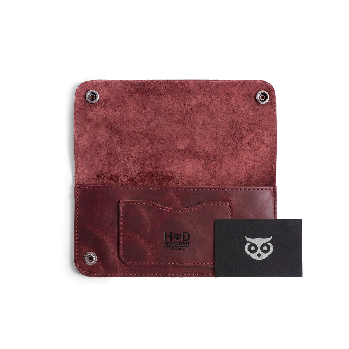 Inside view of the Red Double Snap Folio Wallet by Hide & Drink, detailed with a card slot and cash compartment. This full grain leather wallet combines function and style, making it a great rectangular flat bill holder with card slot and travel accessory, handmade in La Antigua Guatemala & Oaxaca Mexico.