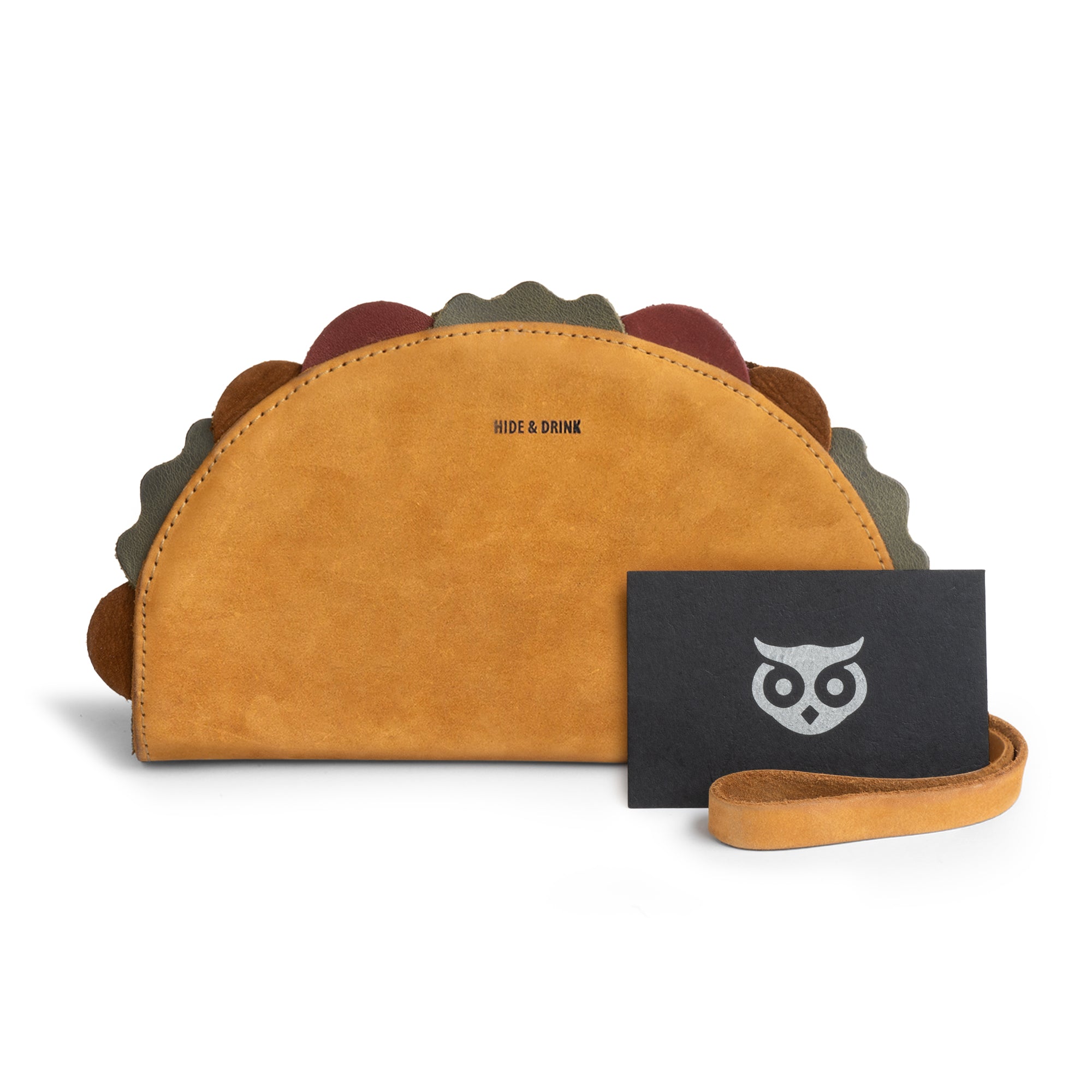 The Handmade Multipurpose Taco Wallet by Hide & Drink alongside a map and accessories, capturing its unique style and versatility, perfect for fun occasions like 5 de mayo. StockyardX, Taco Wallet, 5 de mayo, handmade, women's, phone wallet.