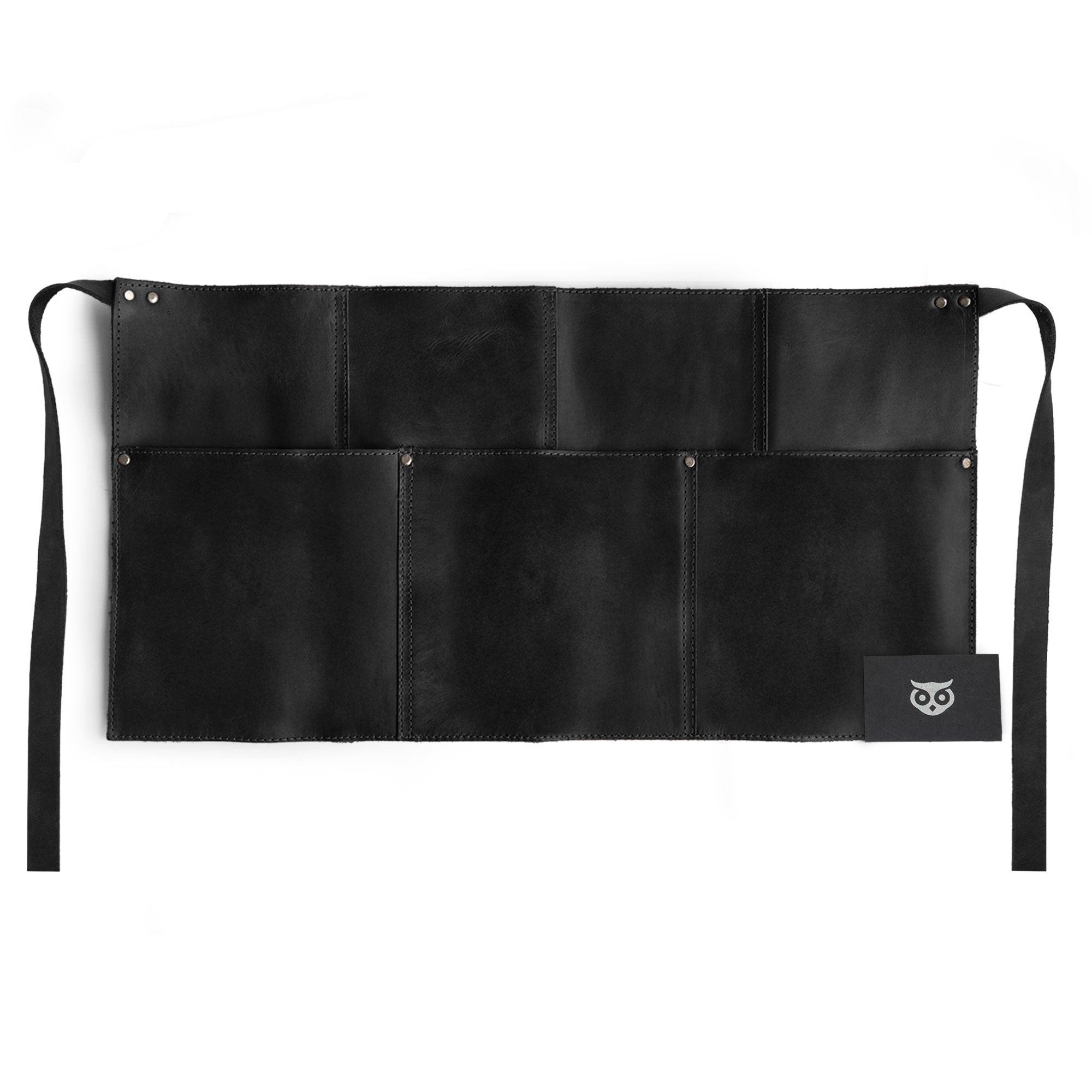 Detail of the black Hide & Drink Barista Leather Waist Apron, highlighting its unique riveted pockets and quality full grain leather. A testament to artisan craftsmanship in La Antigua Guatemala & Oaxaca Mexico.