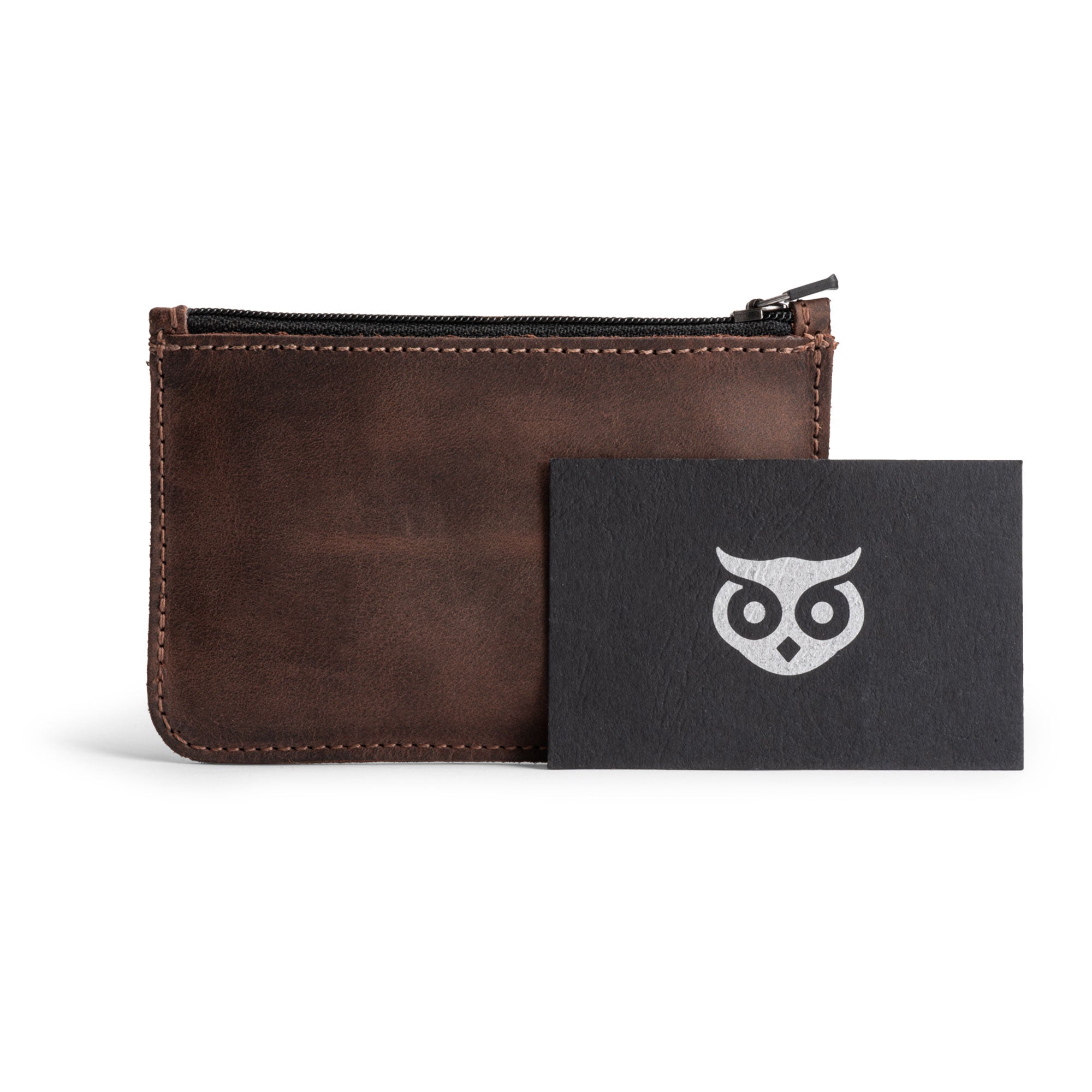 Hide & Drink Zippered Wallet alongside a logo card, illustrating the fine detail and artisan touch. Made with Full Grain Leather, it's an excellent choice for a card case, folded bills storage, and travel accessories — handcrafted in La Antigua Guatemala & Oaxaca Mexico.