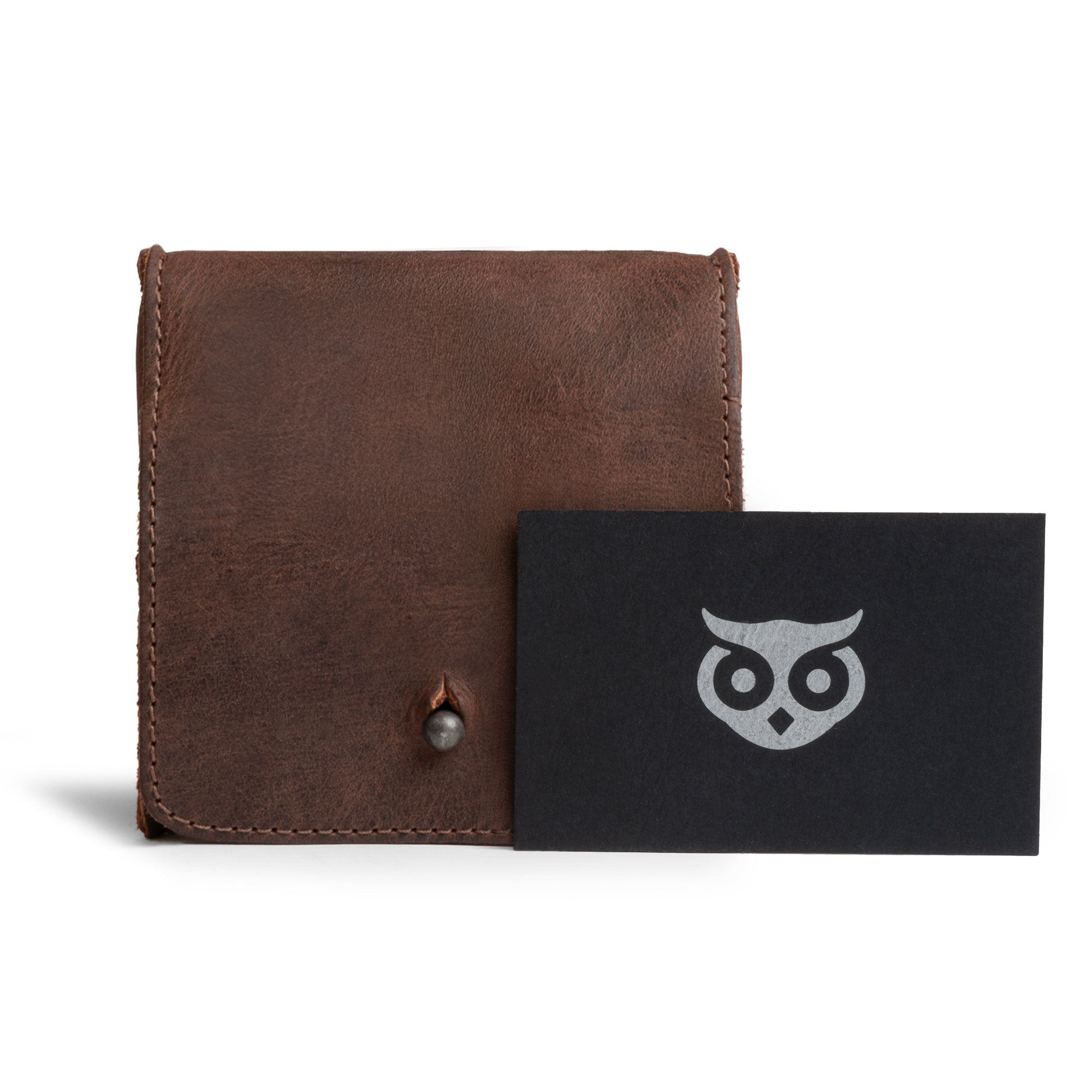 Front view of a Hide & Drink Jewelry Pouch featuring the brand's logo. Crafted from rich full grain leather, this mini mini travel size box is perfect for rings and makes for exceptional groom and bridesmaid gifts, highlighting artisan craftsmanship from Guatemala.