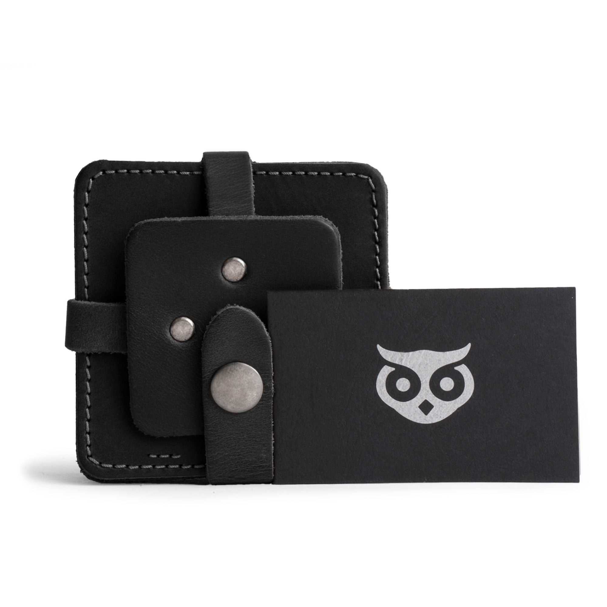 Vintage Squared Coaster (8 pack) by Hide & Drink, displaying a complete set with a business card. This coasters set of 8 doubles as elegant table protection for drinks while maintaining a sophisticated aesthetic. Made with fine full grain leather, this artisan piece is thoughtfully produced in small batches, highlighting hand cut, hand sewn techniques, and fire branding from La Antigua Guatemala & Oaxaca Mexico.