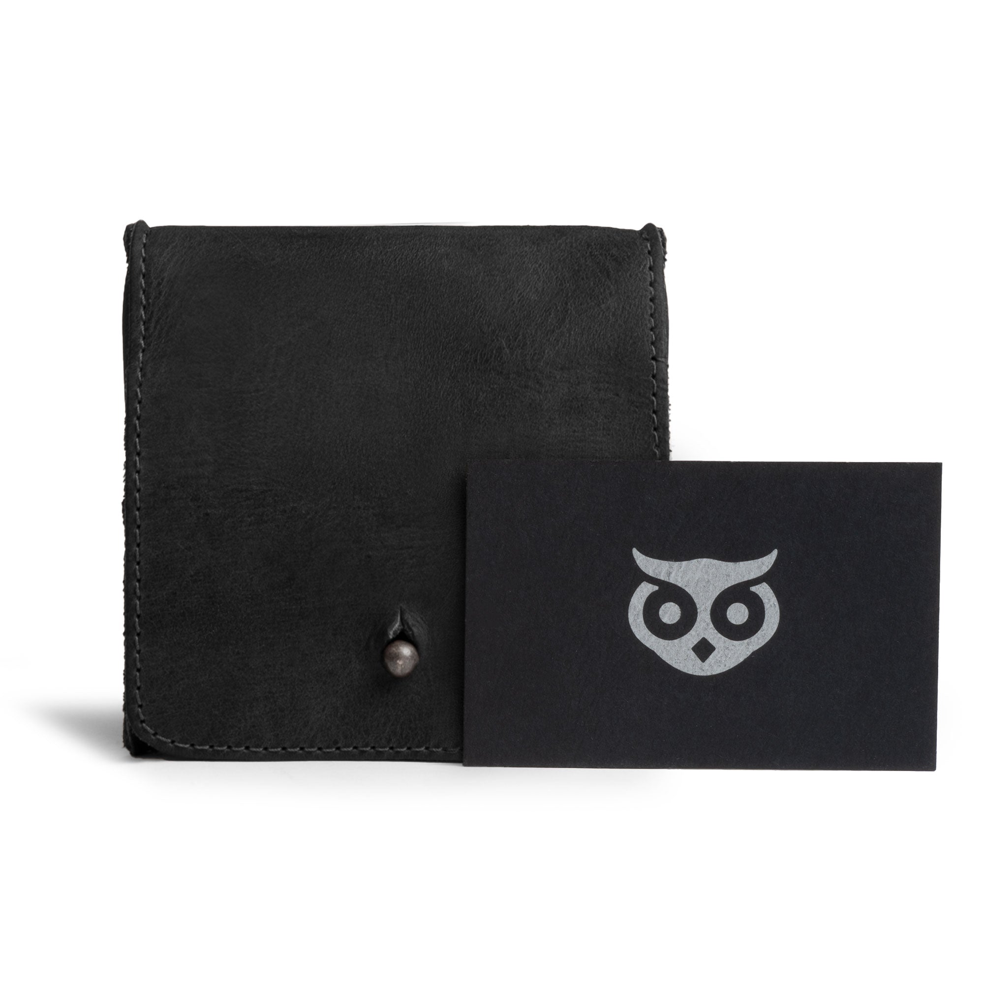 Front view of a Hide & Drink Jewelry Pouch featuring the brand's logo. Crafted from rich full grain leather, this mini mini travel size box is perfect for rings and makes for exceptional groom and bridesmaid gifts, highlighting artisan craftsmanship from Guatemala.