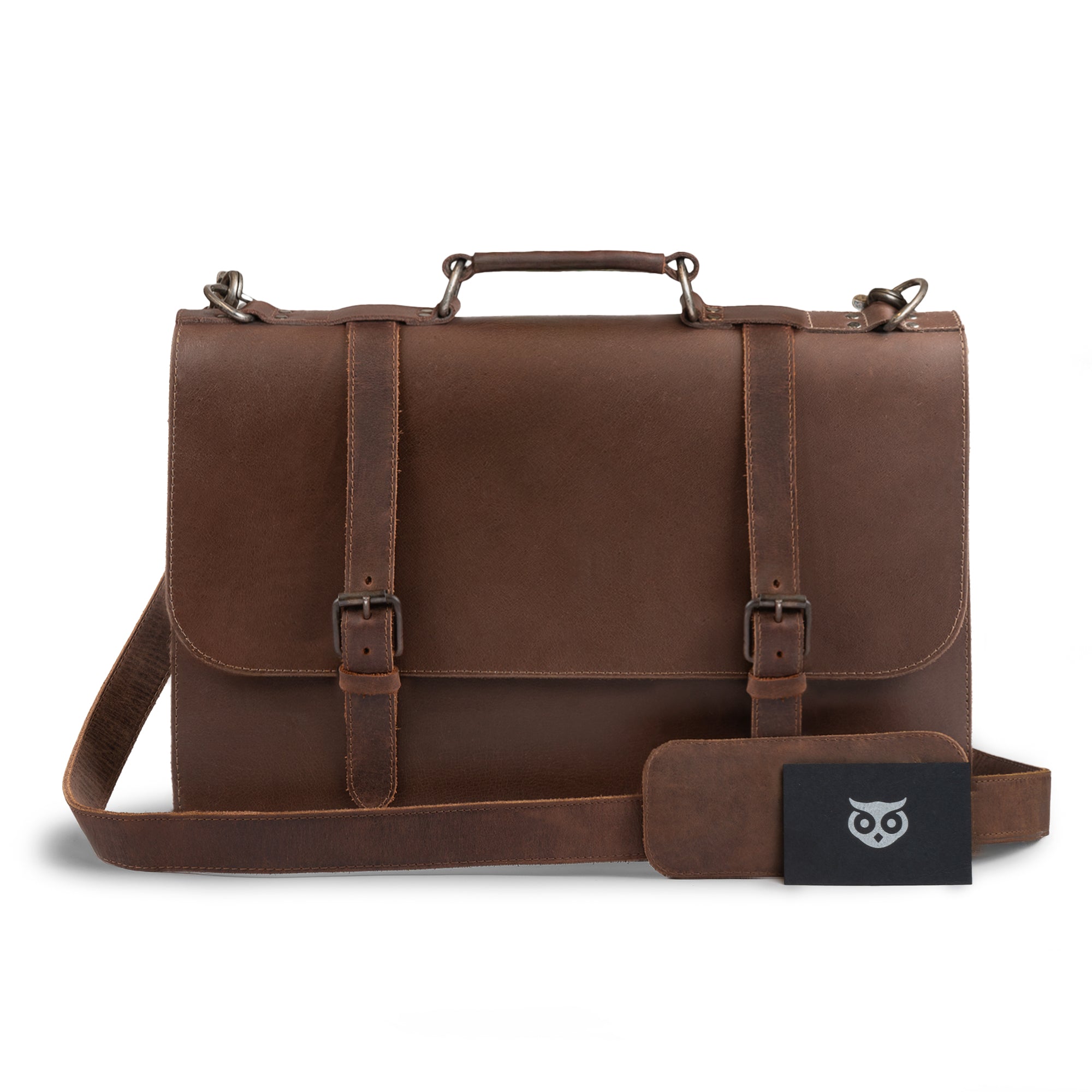 Front view of the Hide & Drink two-compartment chunky messenger bag, showcasing its spacious design and laptop compartment. This rustic briefcase with adjustable shoulder strap is a durable messenger bag and ideal travel accessory, crafted from premium full-grain leather with artisanal details cut and sewn by hand. Produced in La Antigua, Guatemala and Oaxaca, Mexico.