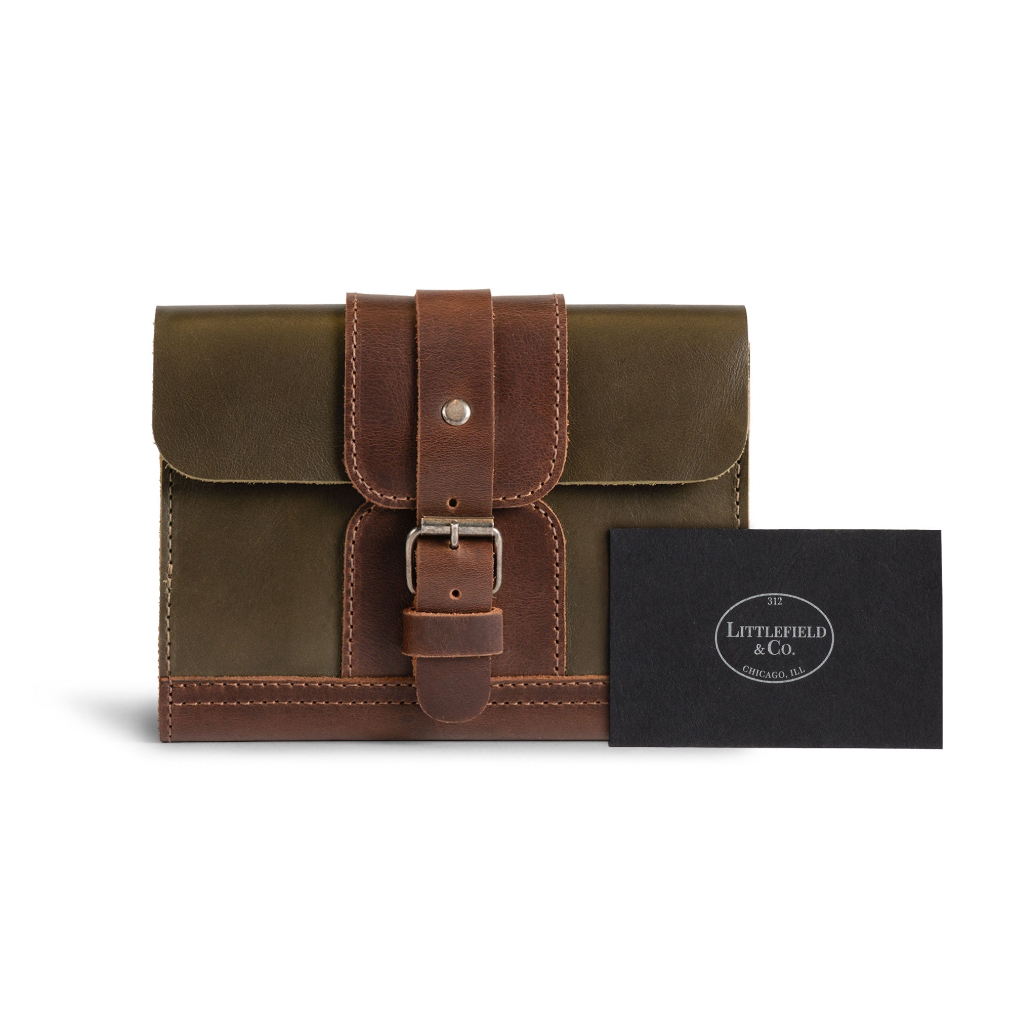 The Vintage Adventure Passport Cover by Littlefield Chicago presented with a business card, showing off its craftsmanship and signature design. This passport wallet, made from Full Grain Leather, is both a stylish accessory and a practical wallet organizer, supporting the artistry of small batch production artisans.
