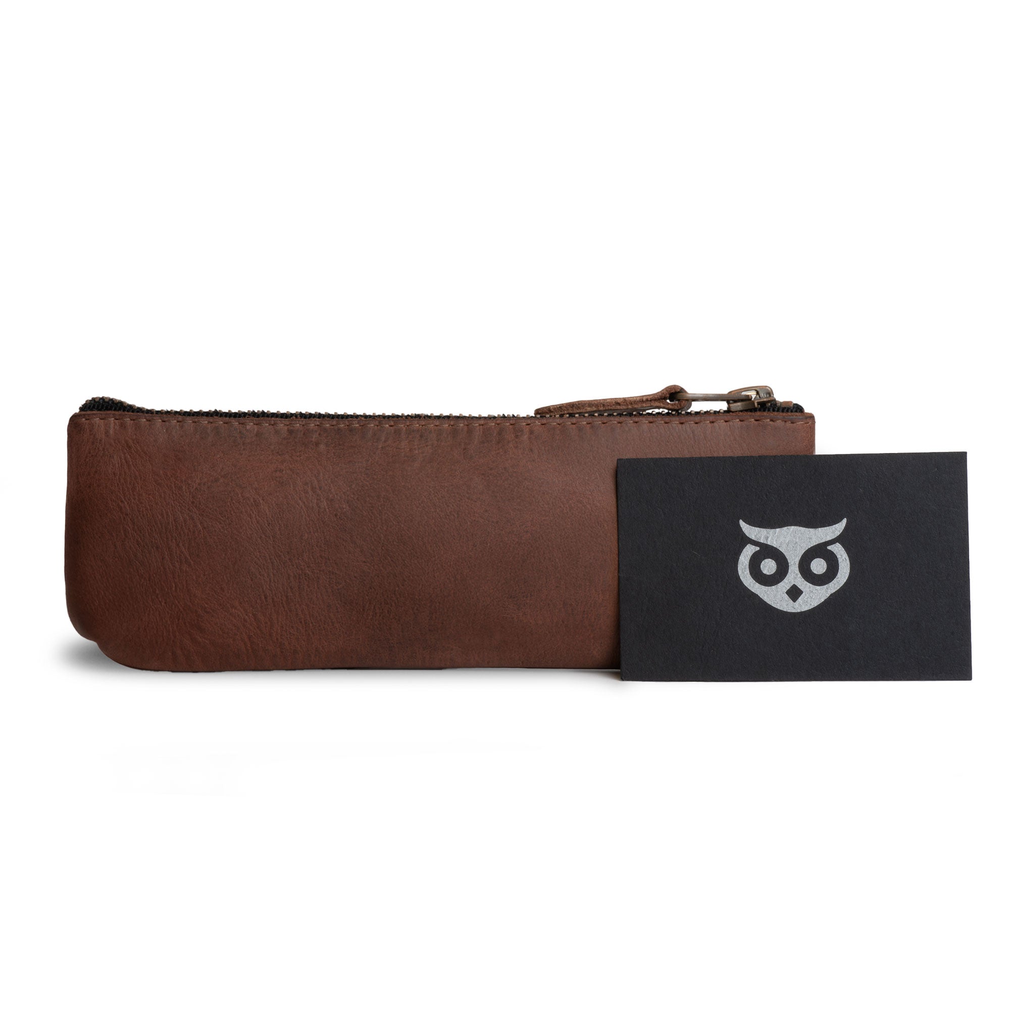 Hide & Drink Pencil Pouch alongside its authenticity cards, showcasing a unique and stylish rectangular design in full grain leather. Ideal as a pen & marker pouch for both men and women, it features a flat zippered holder. Artisan-crafted in La Antigua Guatemala & Oaxaca Mexico, known for its small batch production.