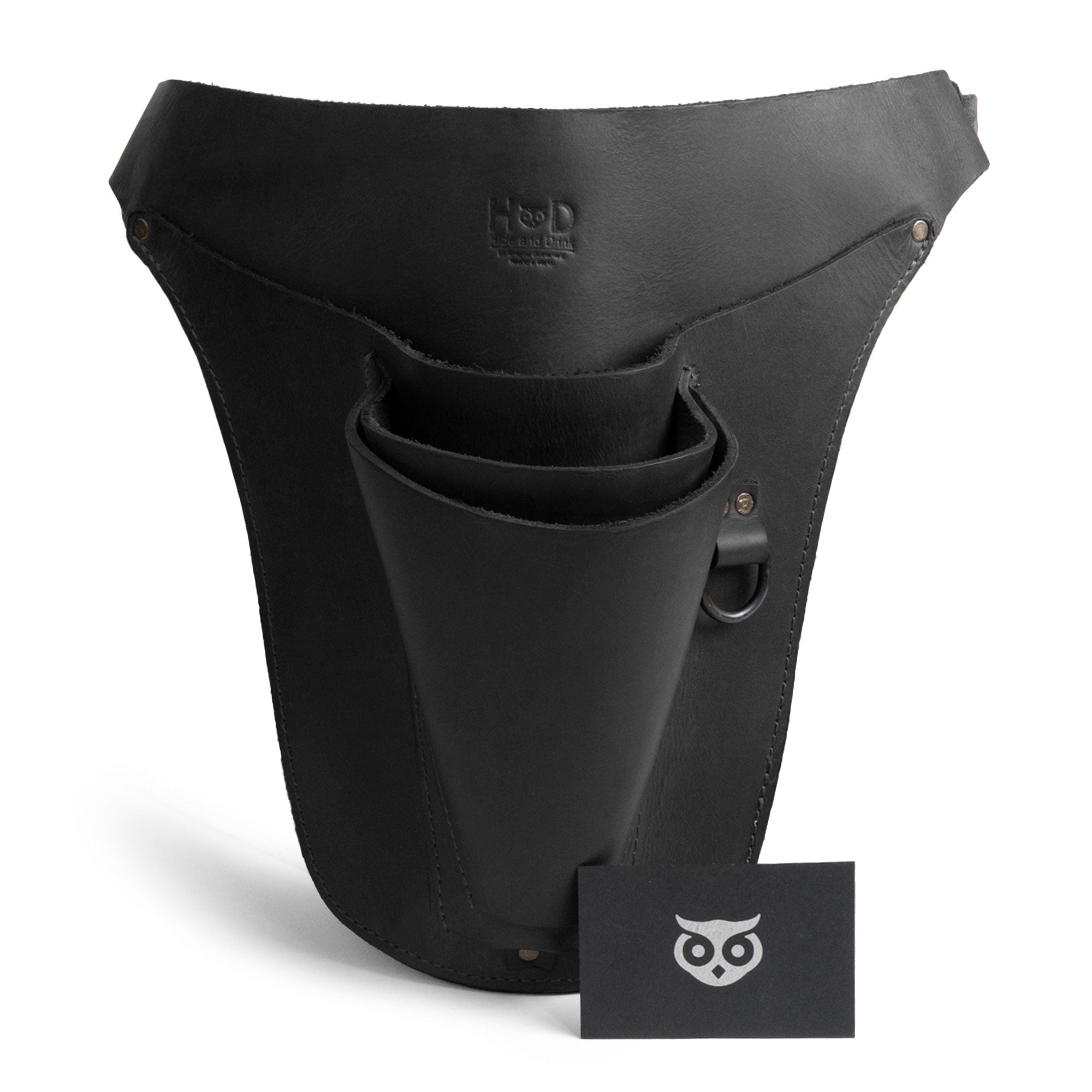 Hide & Drink's black Florist Tool Belt alongside its business card, emphasizing quality craftsmanship in Full Grain Leather. This Florist Tool Belt for Men & Women is adjustable and versatile, perfect for gardening and various crafts. Artisan handmade in La Antigua Guatemala & Oaxaca Mexico, emphasizing unique design.
