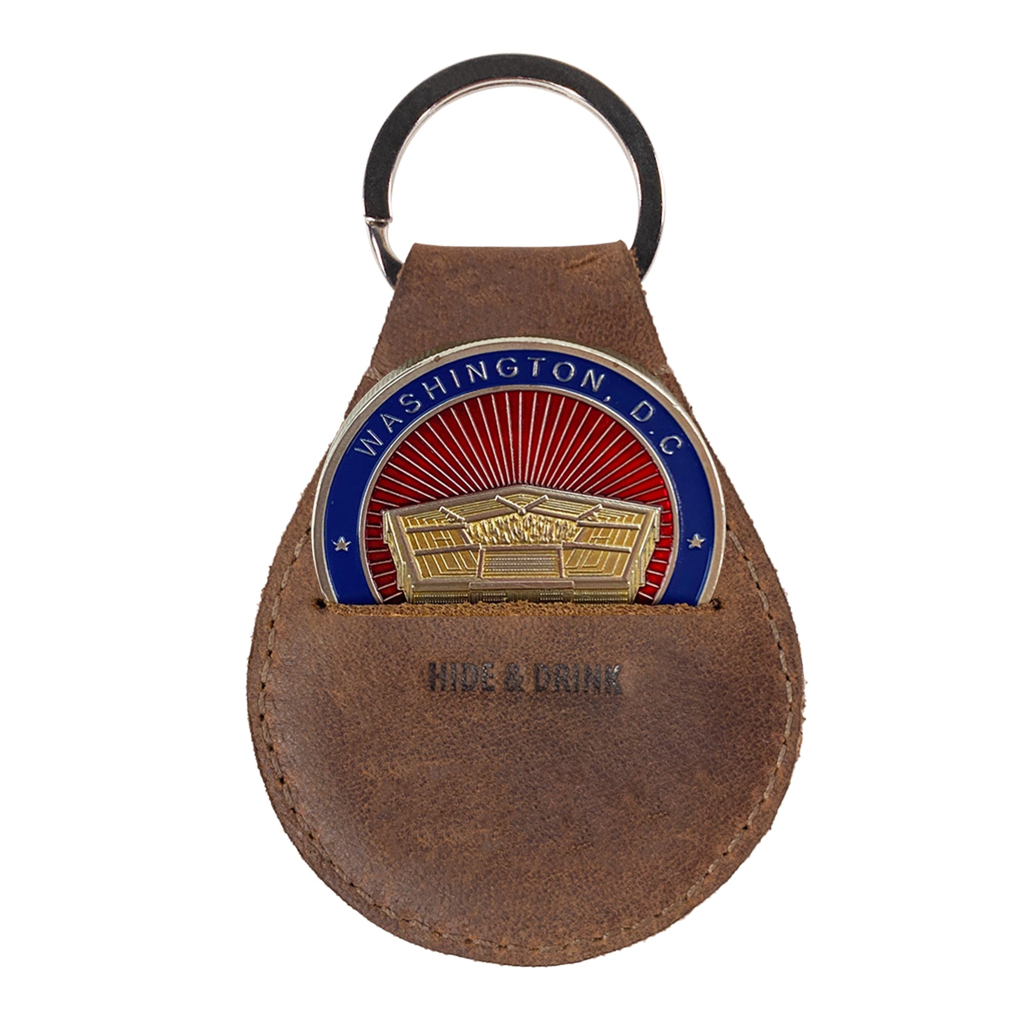 The Medallion Holder Keychain by Hide & Drink displaying a commemorative medallion, highlighting its secure keyring attachment for keeping precious keepsakes and coins. Made from durable full grain leather, this handmade item reflects the care and craftsmanship from artisans in La Antigua Guatemala & Oaxaca Mexico.