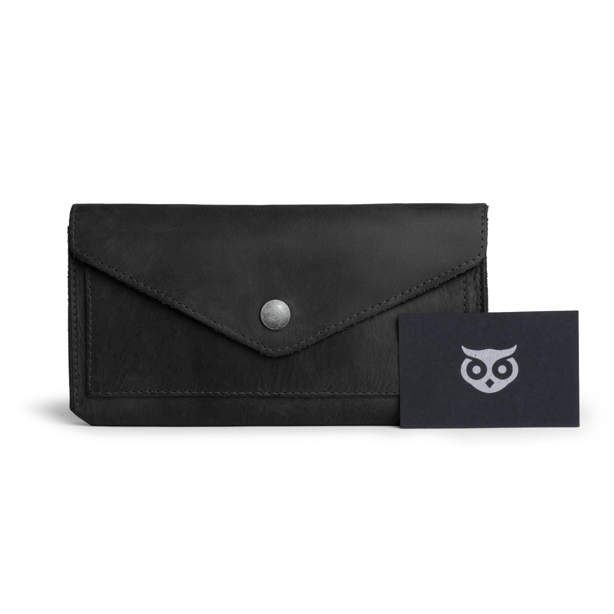 Large Female Wallet by Hide & Drink with tags showing its artisan roots. This Vintage Money and Card Holder is made from Full Grain Leather and is designed as a Travel Organizer for Women, reflecting the small batch production and dedication of its makers.