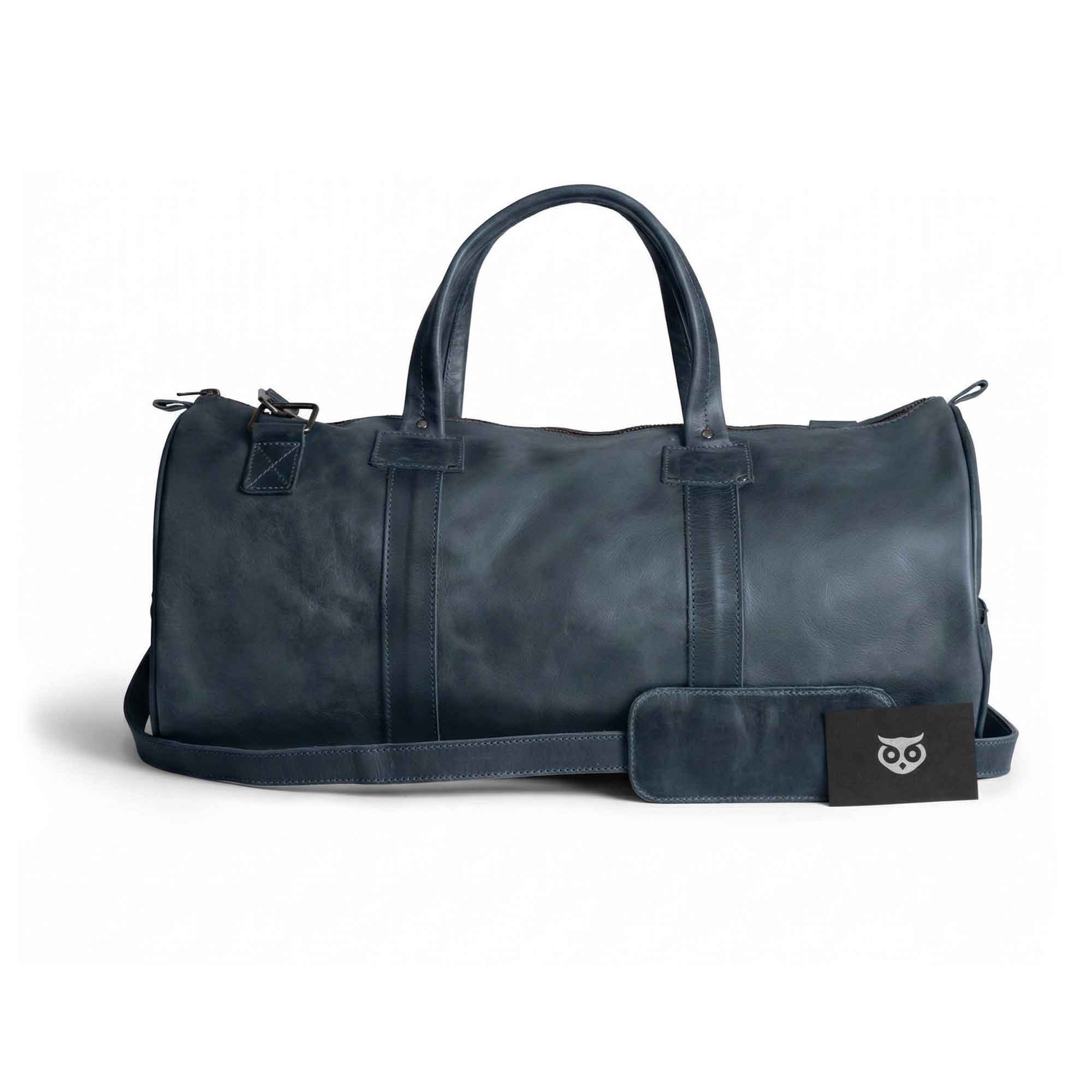 Beautiful view of the Classic Duffle Bag by Hide & Drink in dark brown leather, featuring an elegant design with zipper closure and adjustable strap. This versatile Full Grain Leather Classic Duffle Bag serves as a perfect Messenger Bag, handmade by artisans in La Antigua Guatemala & Oaxaca Mexico.